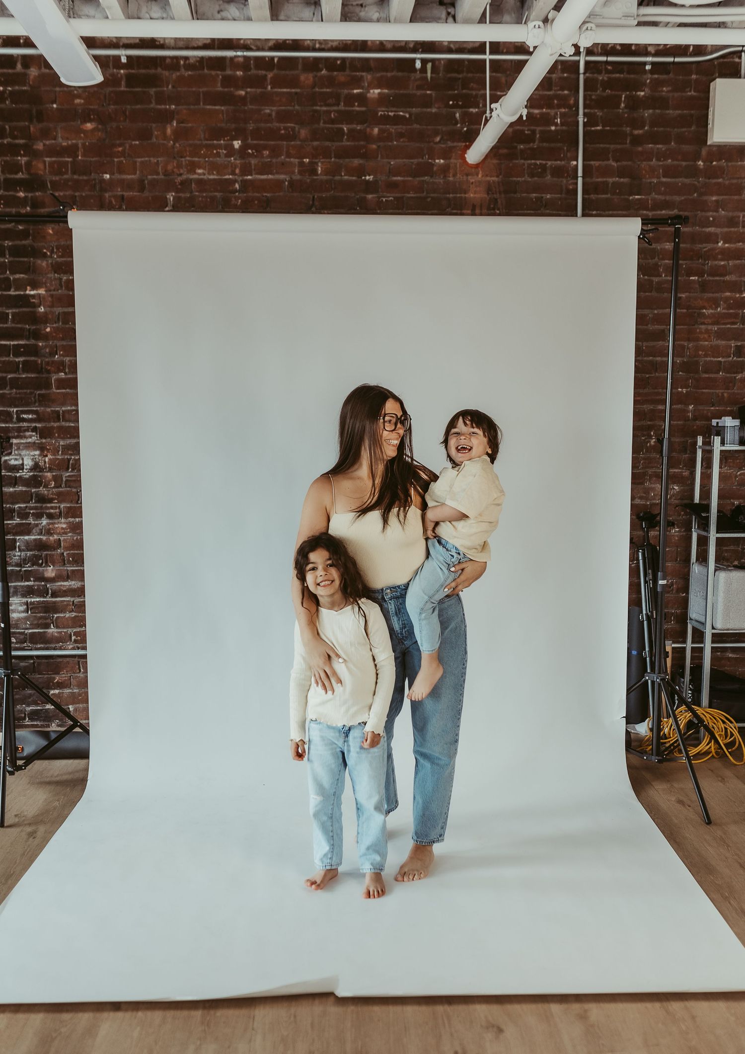 studio photo session with mother and her two kids wearing butter yellow