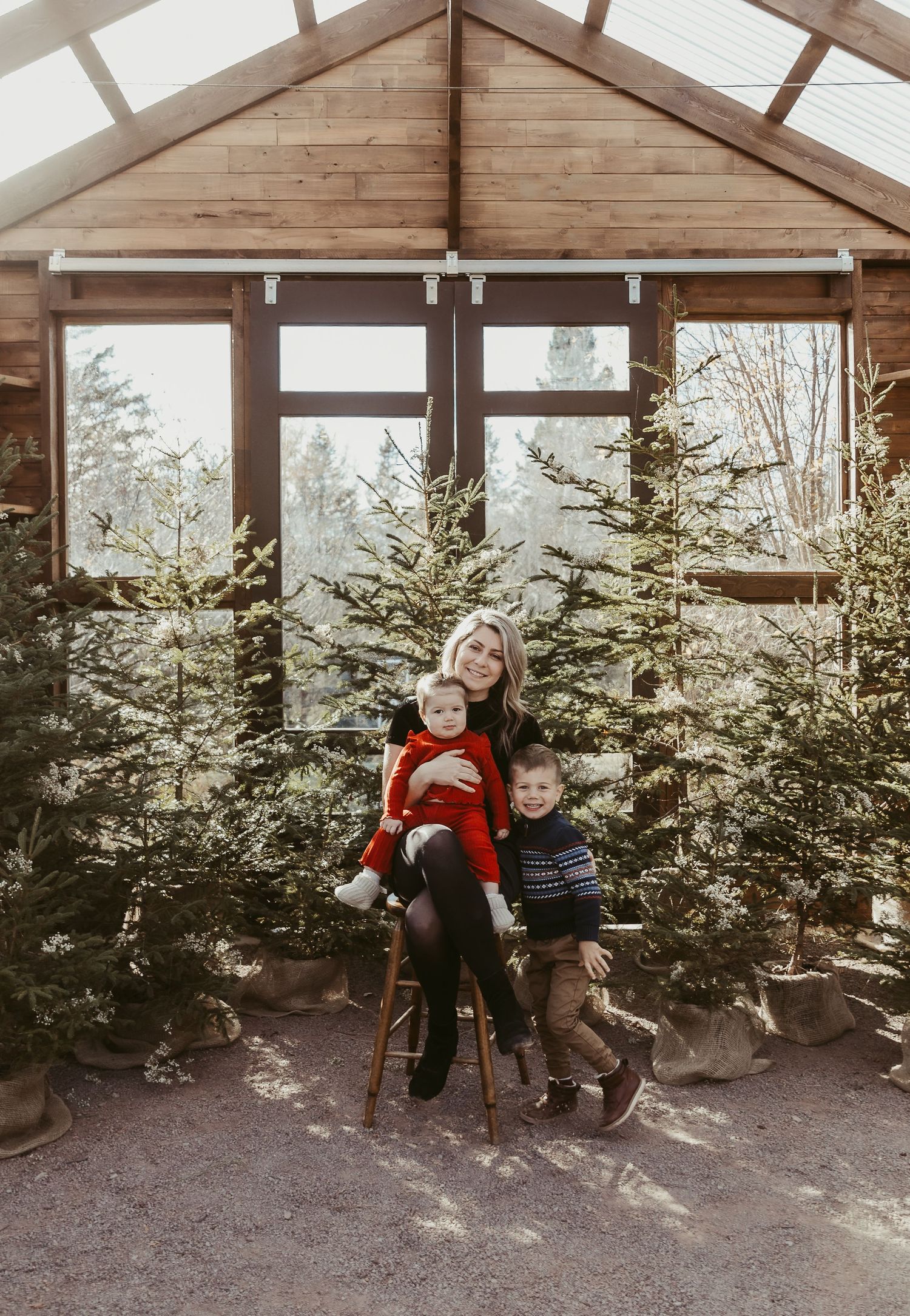 mom and her two kids in a greenhouse