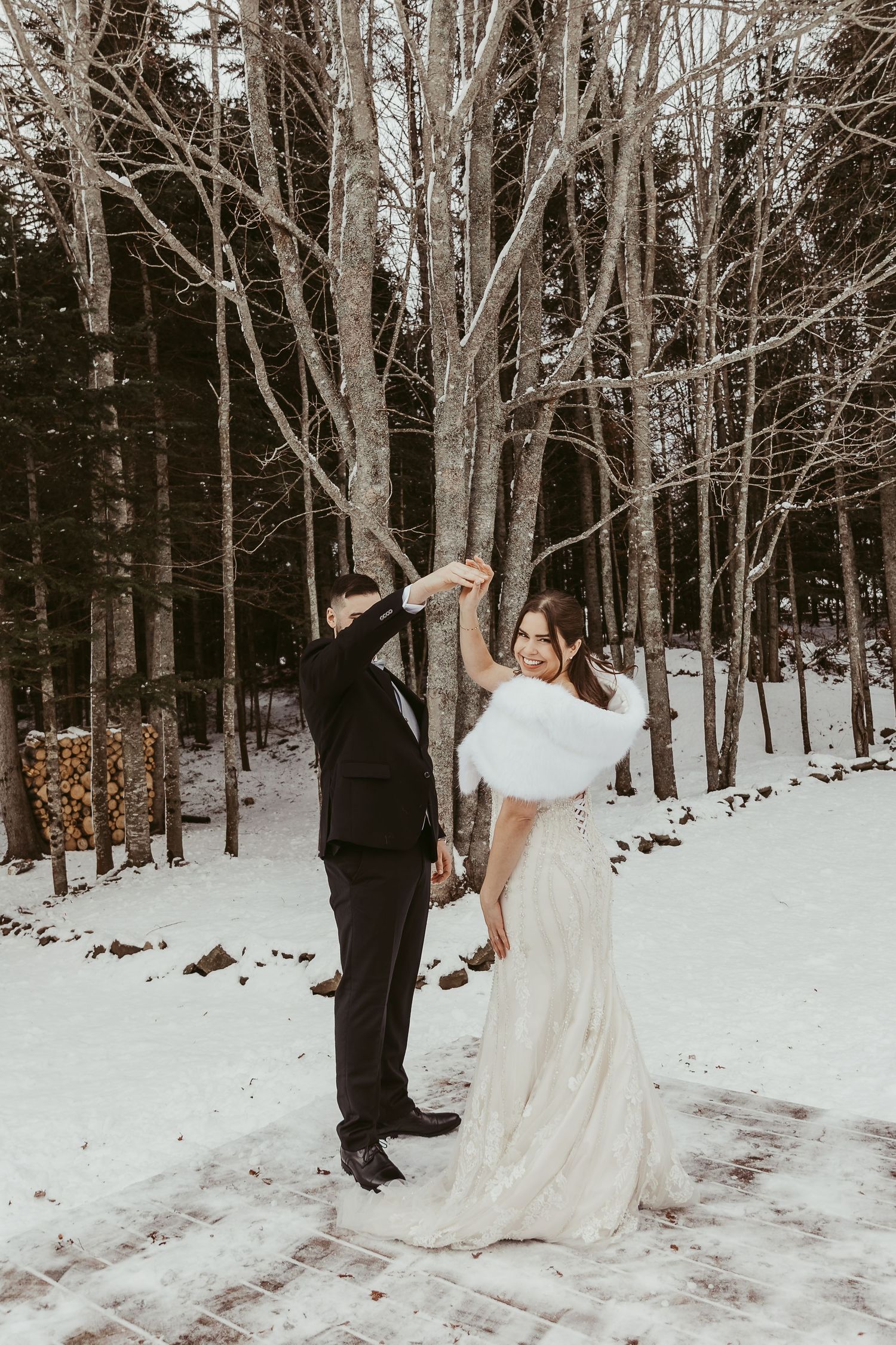 winter bride an dgroom dancing in the snow