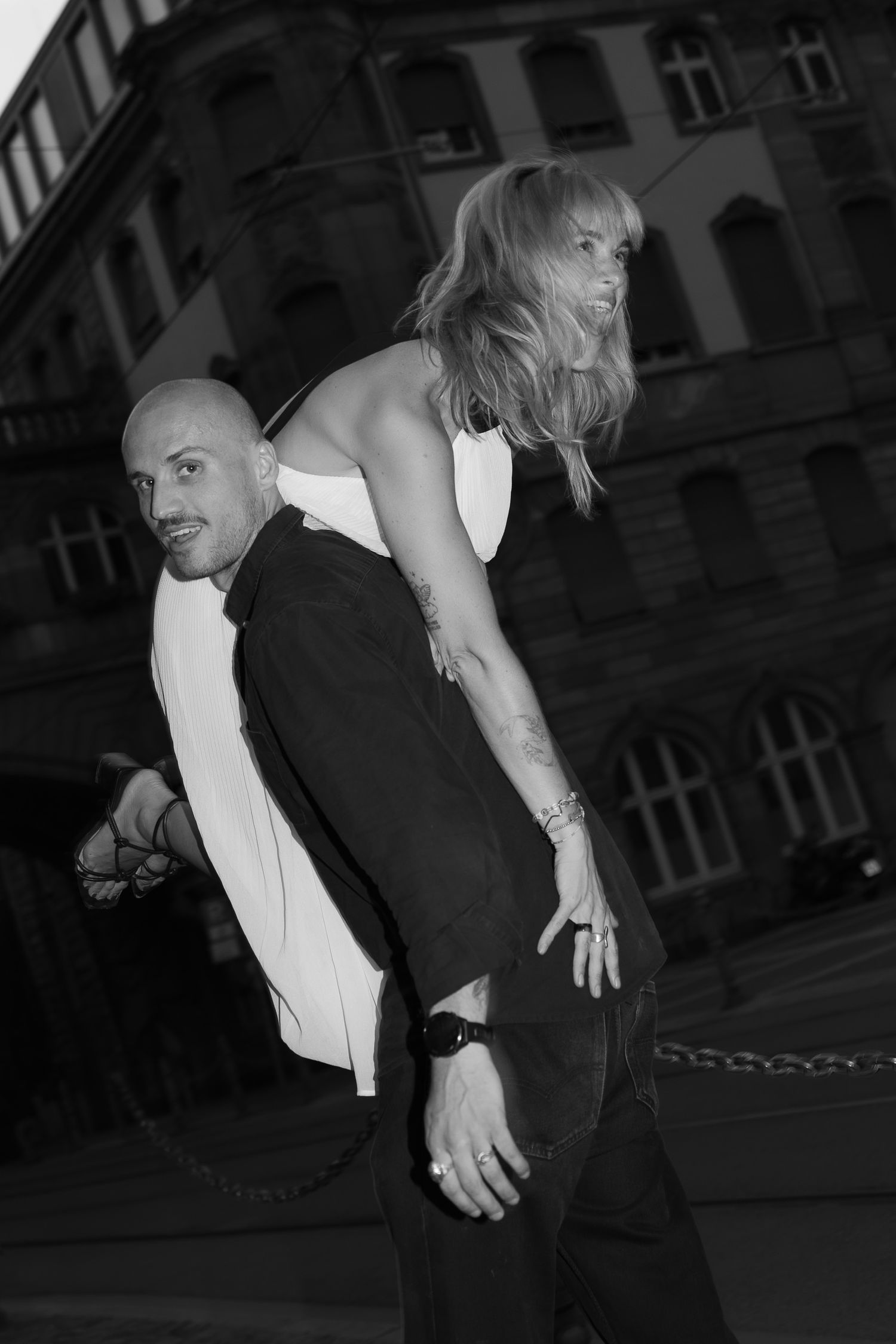 Couple posing playfully together in the city