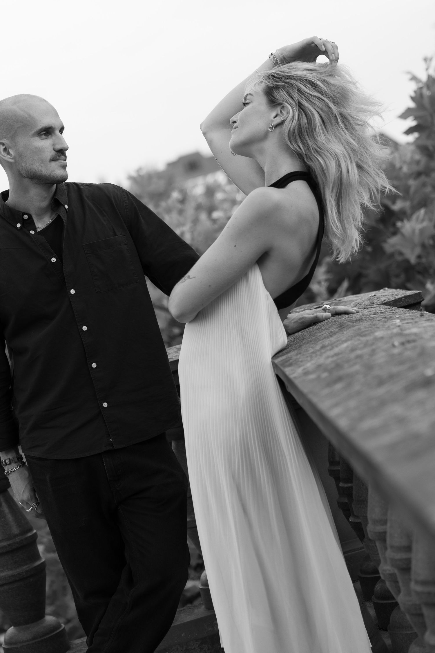 Couple sharing a close black and white portrait while wind is blowing through her hair