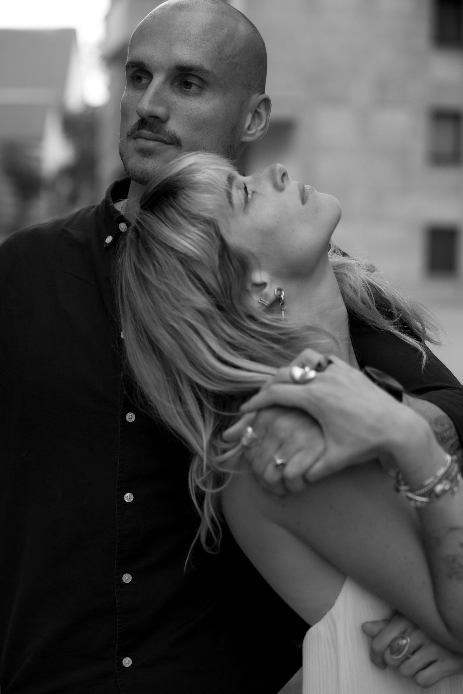 Couple posing playfully together in the city