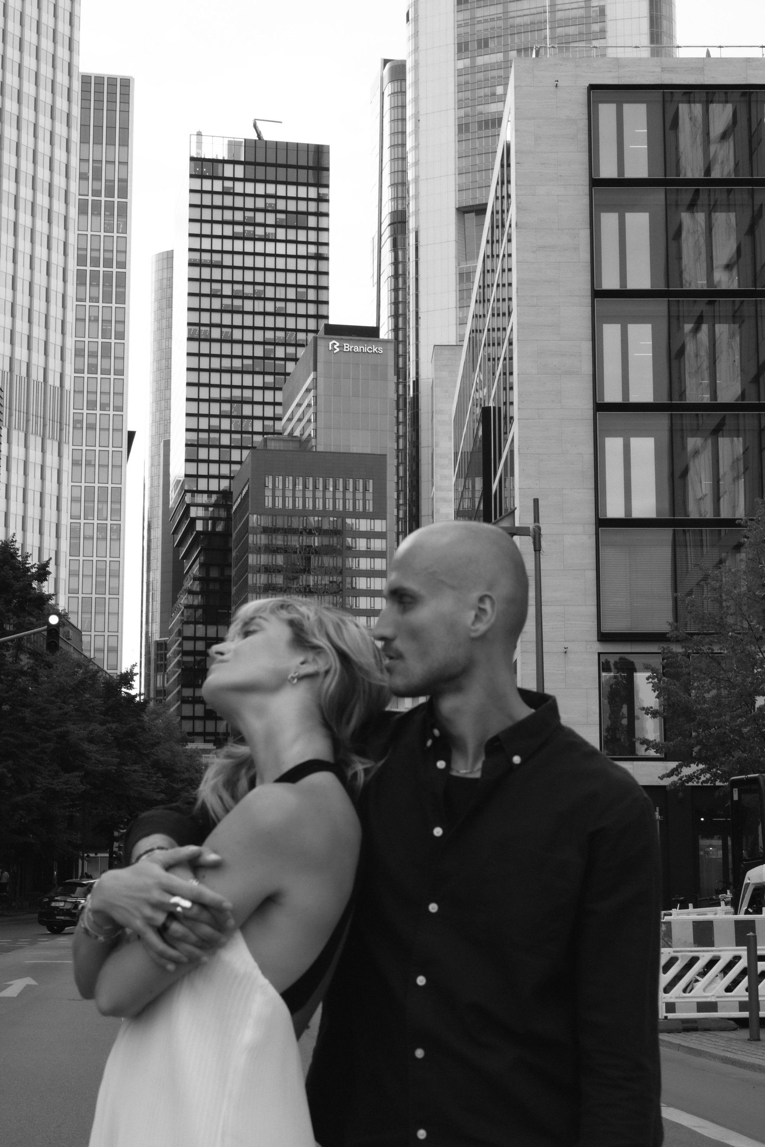 Couple playing together on a city street surrounded by skyscrapers