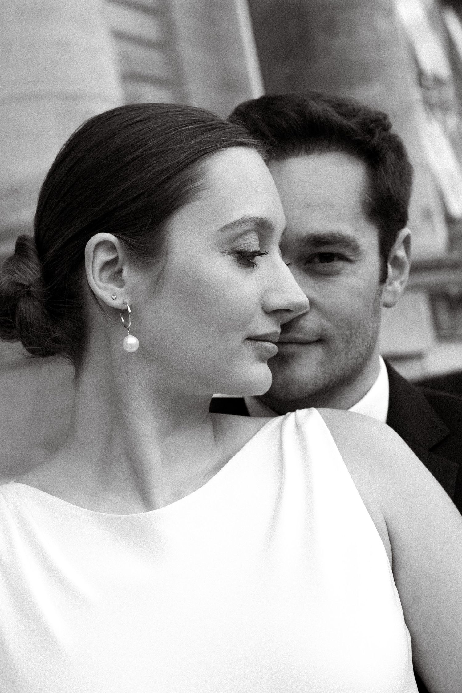 Newlyweds sharing a close black and white portrait