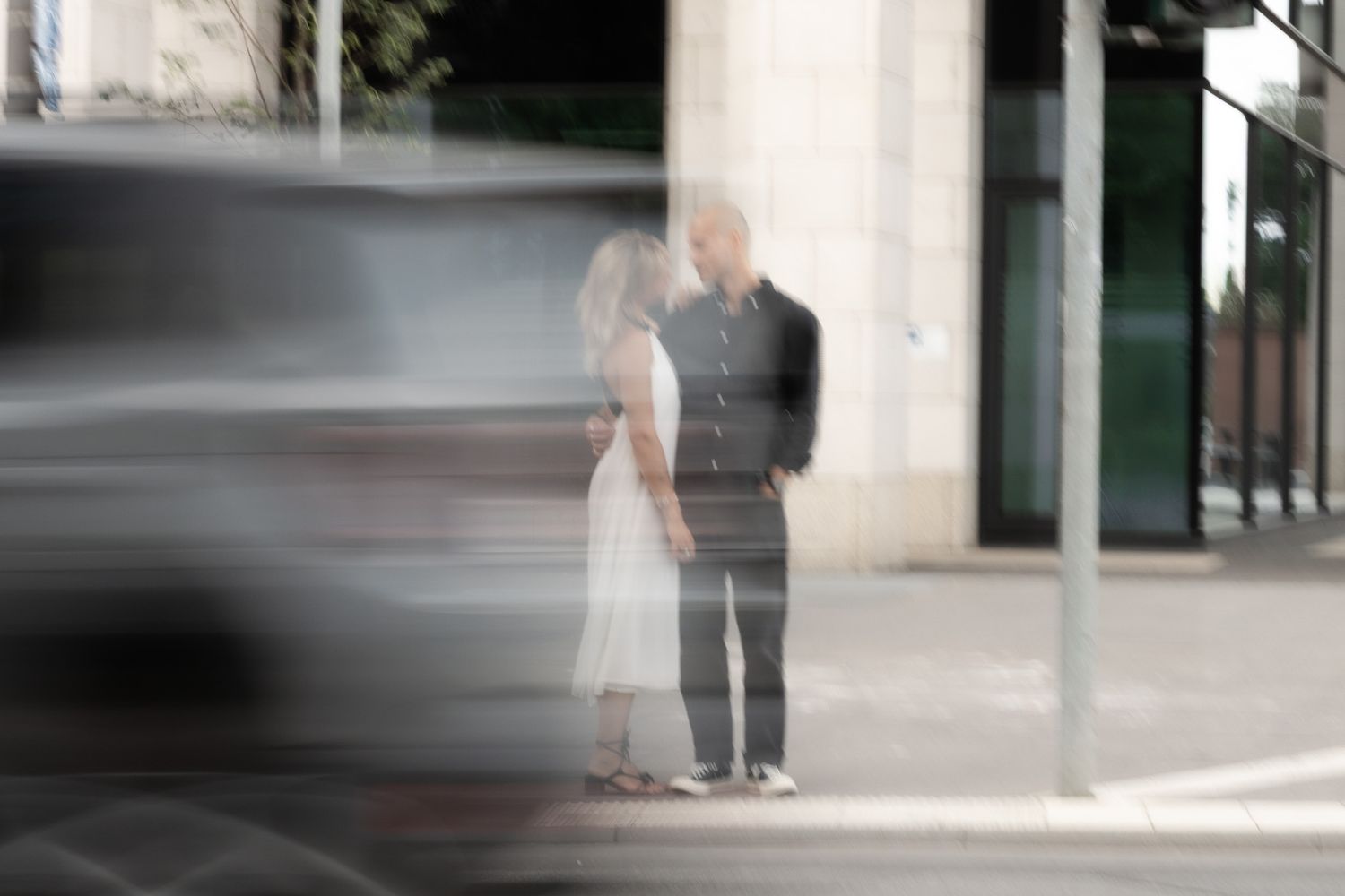 Couple kissing on a city street captured with intentional motion blur