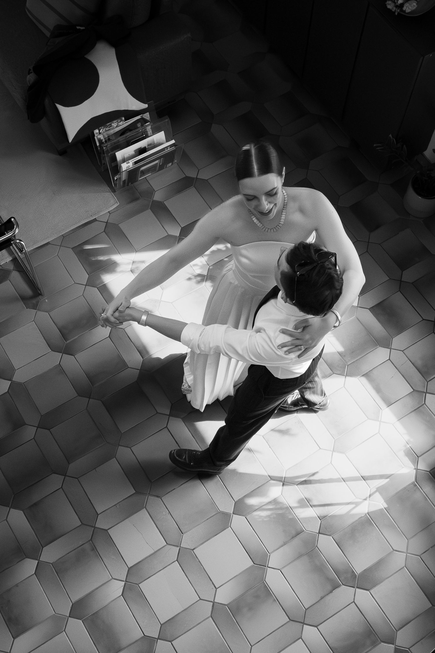 Newlyweds dancing together in a sunlit interior