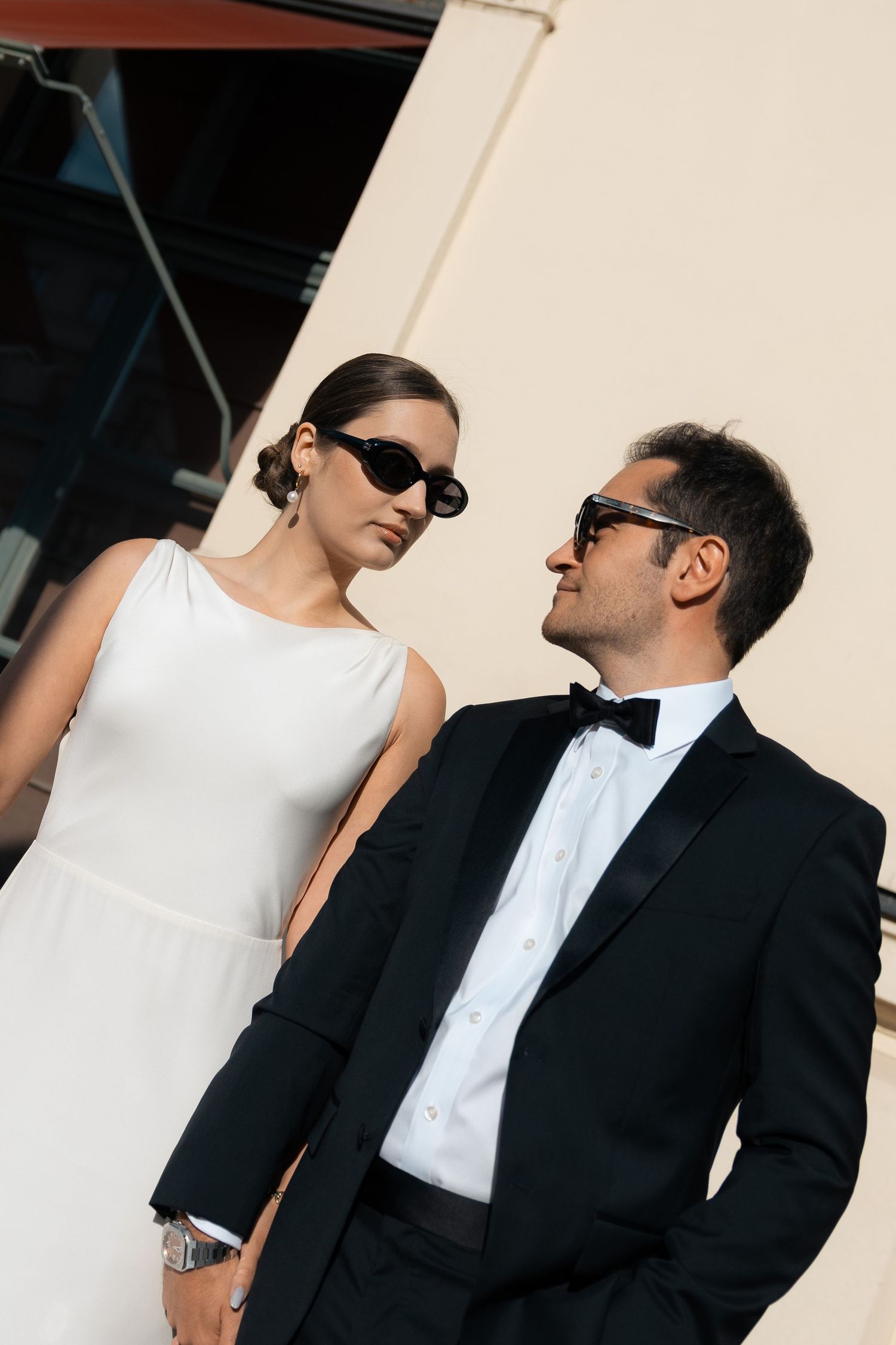 Newlyweds in sunglasses posing together in the city