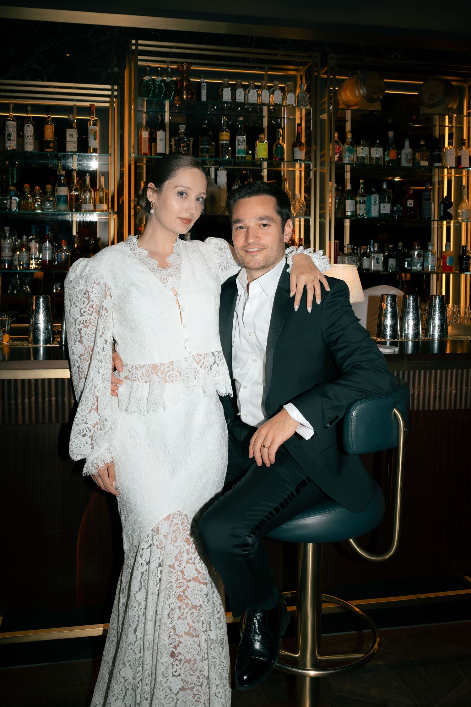 Newlyweds posing together at a stylish bar