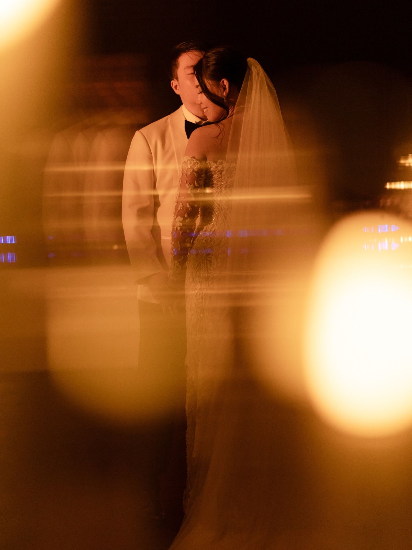 Warm-toned candlelit portrait: Timeless emotions captured in every frame to preserve your wedding legacy.