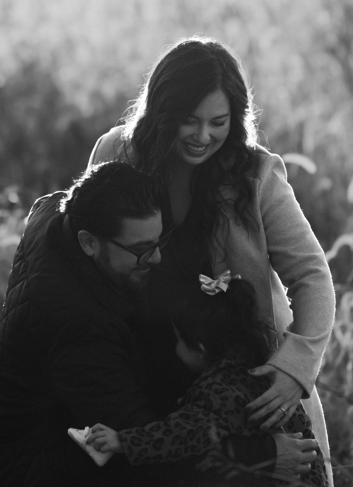 Black and white photo of a couple smiling and bonding outdoors in nature.