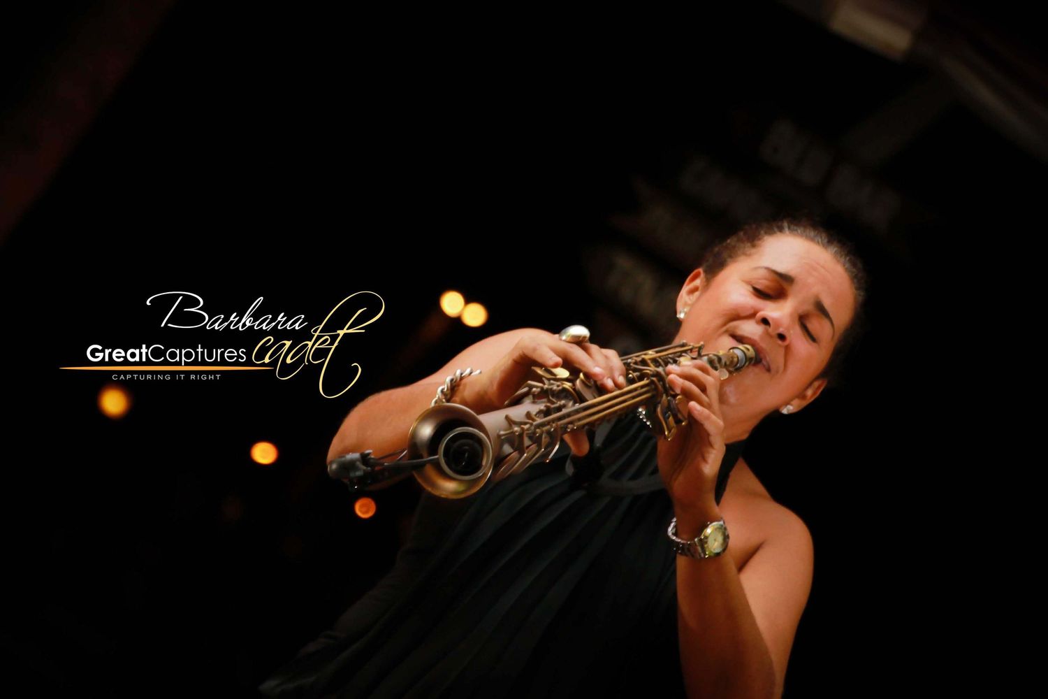 A woman passionately plays a saxophone on stage under warm stage lights at a live jazz performance.
