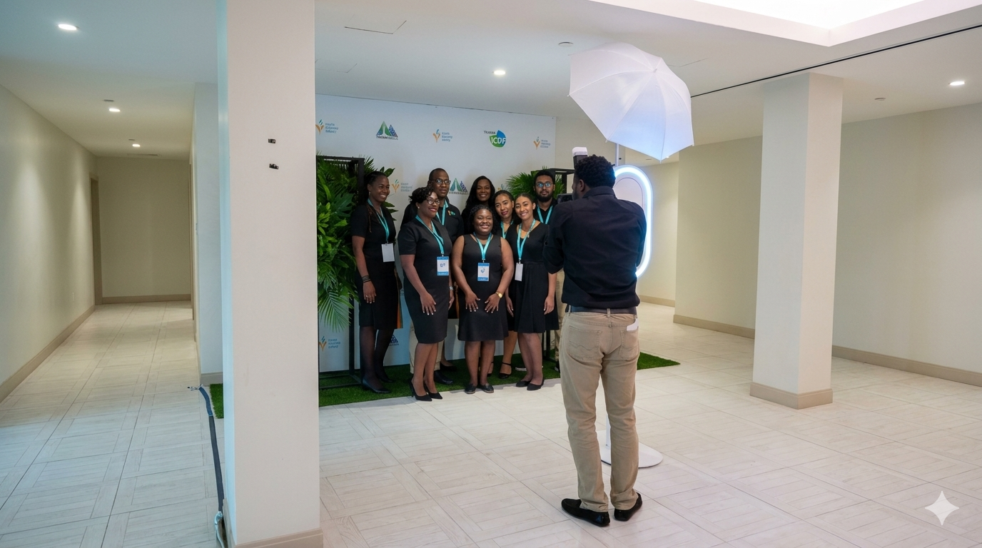 Photographer capturing a group photo of professionally dressed women at a corporate event.