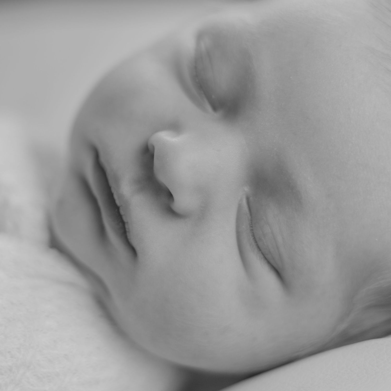 A serene grayscale photograph shows a resting figure in soft, dreamy lighting creating a peaceful, contemplative mood.