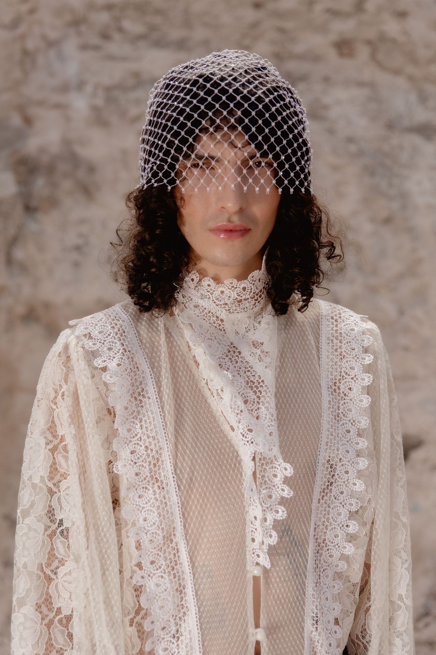 A bride wearing a vintage-inspired lace wedding dress and birdcage veil poses in a series of four portraits.