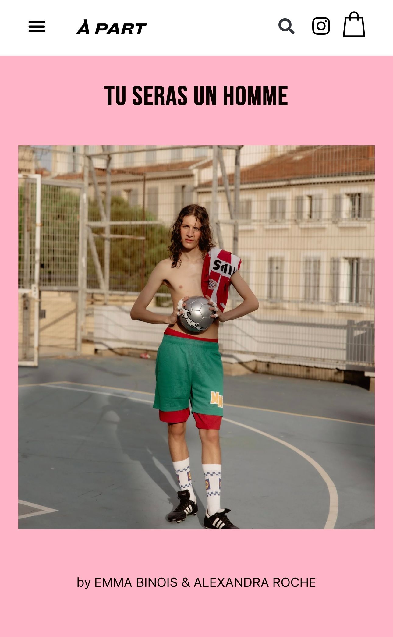 Basketball player wearing red and green athletic shorts poses on an outdoor court at sunset.