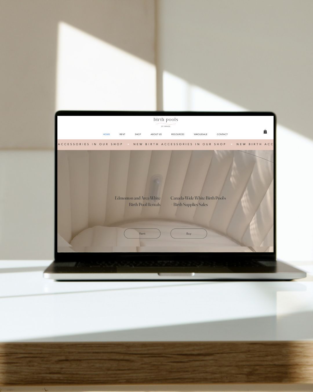 A sleek MacBook laptop shown from multiple angles on a white surface with natural lighting casting soft shadows.