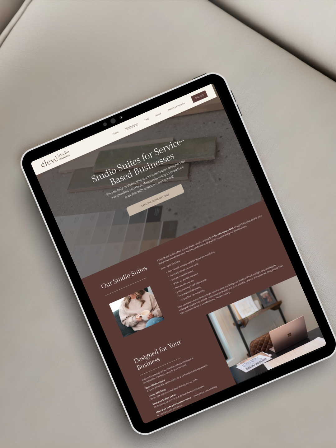 iPad tablet displaying a minimalist website design with brown and gray color scheme showing interior design content.