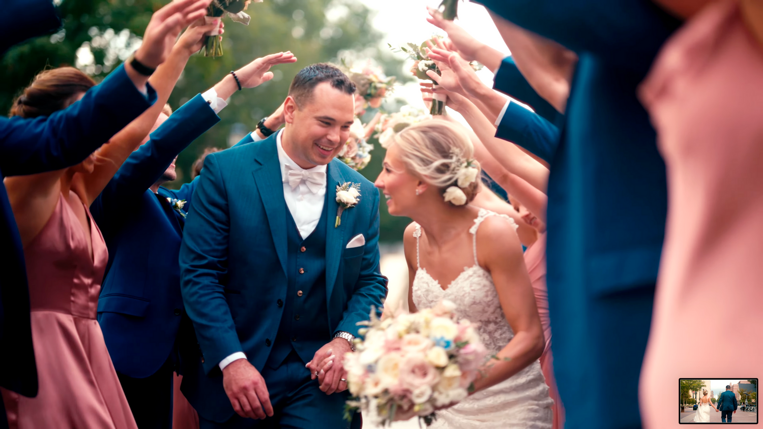 A wedding party celebrates with guests under festive lighting and decorations.
