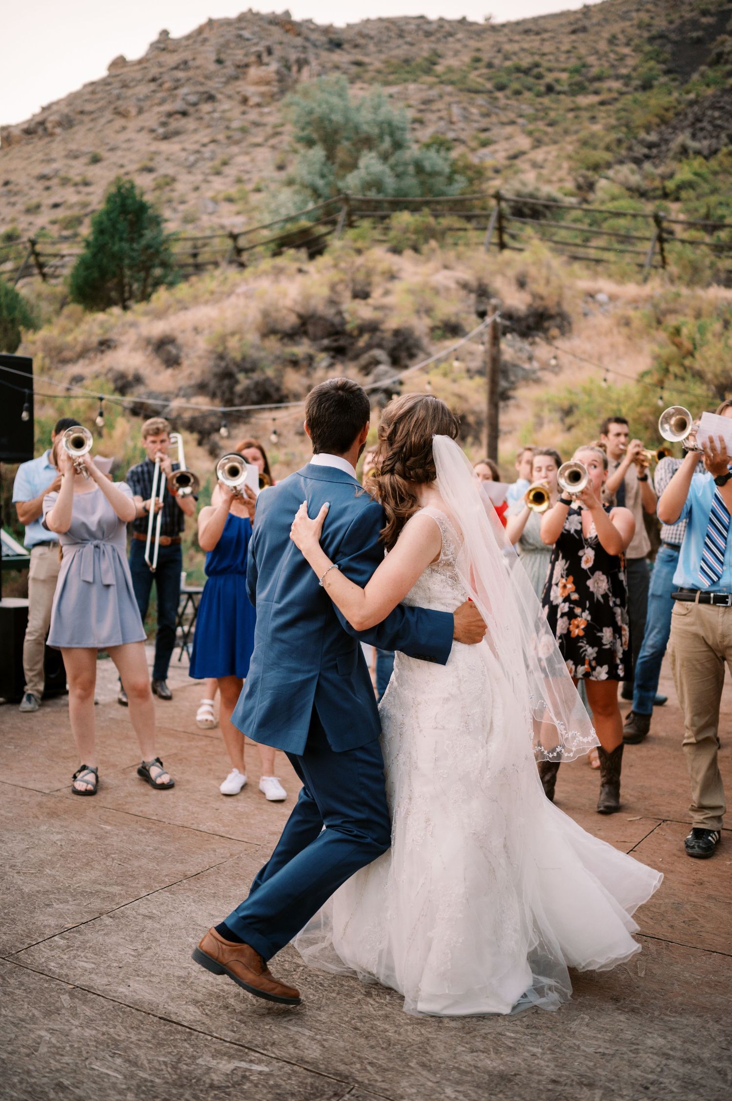 Newlyweds share their first dance at an outdoor mountain wedding reception.