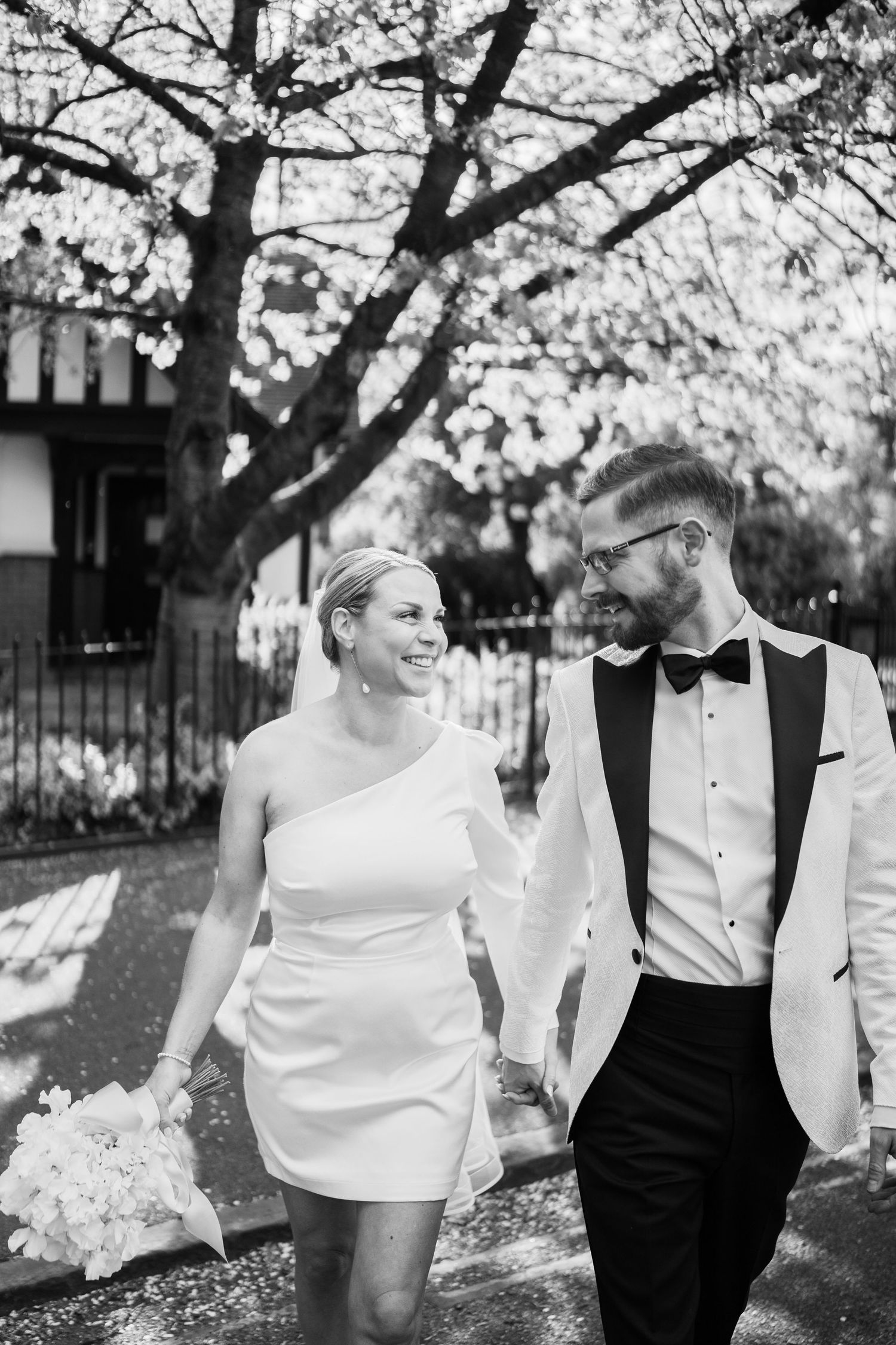 Bride and groom holding hands through The Park Estate, Nottingham, captured in a relaxed, natural moment during their city centre elopement.