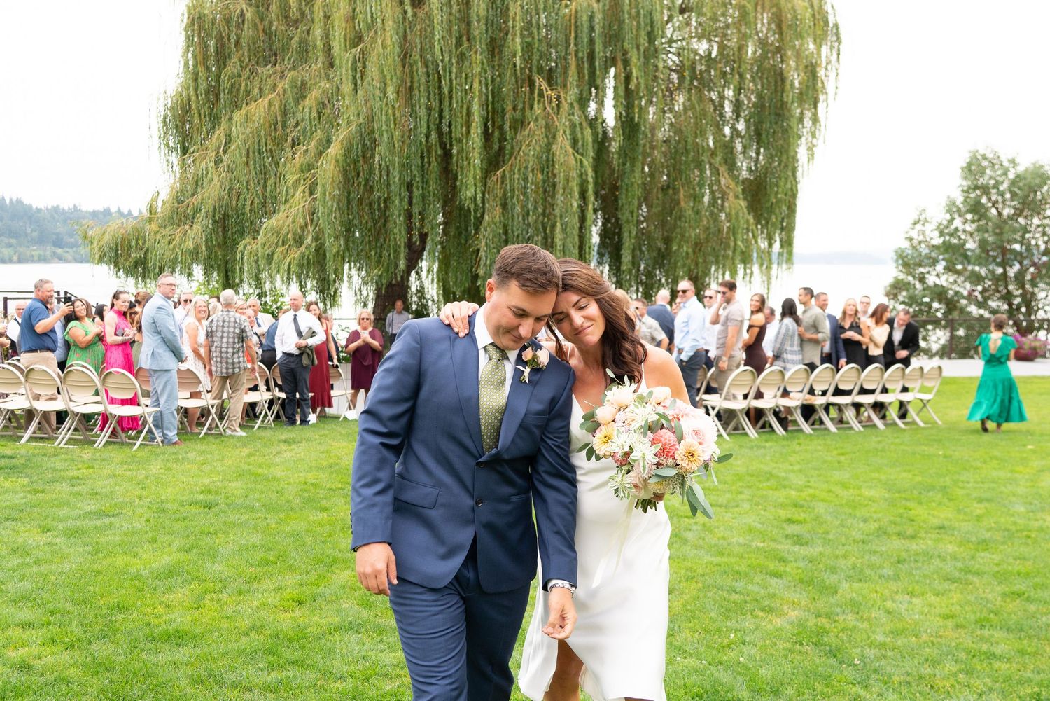 A bride and groom sharing a moment after the ceremony on Bainbridge Island, WA. Captured by Savvy Photography - PNW Wedding Photographer