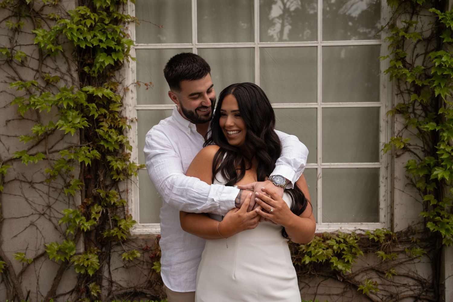 Engaged couple hugging and laughing during a pre wedding photoshoot
