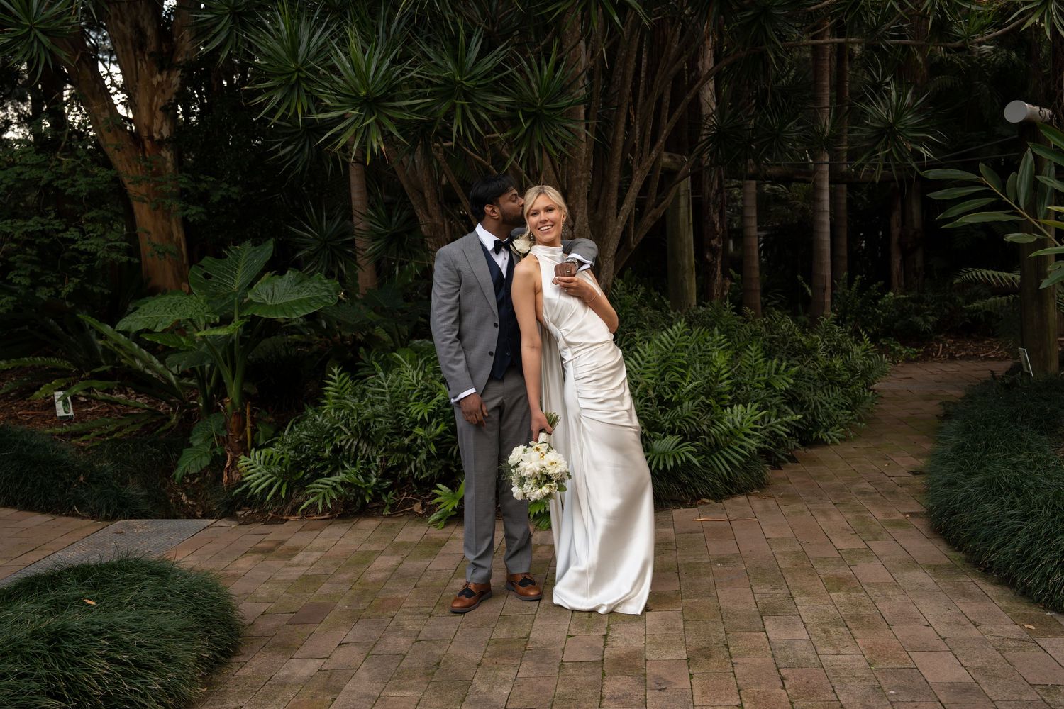 Bride and groom connecting and laughing at Wollongong Botanical Gardens.