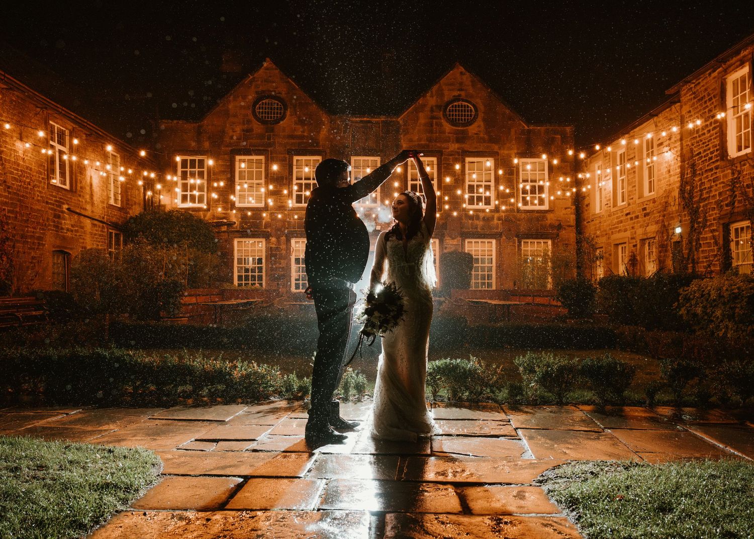 A romantic silhouette illuminated by dramatic backlighting in front of Whitley hall hotel