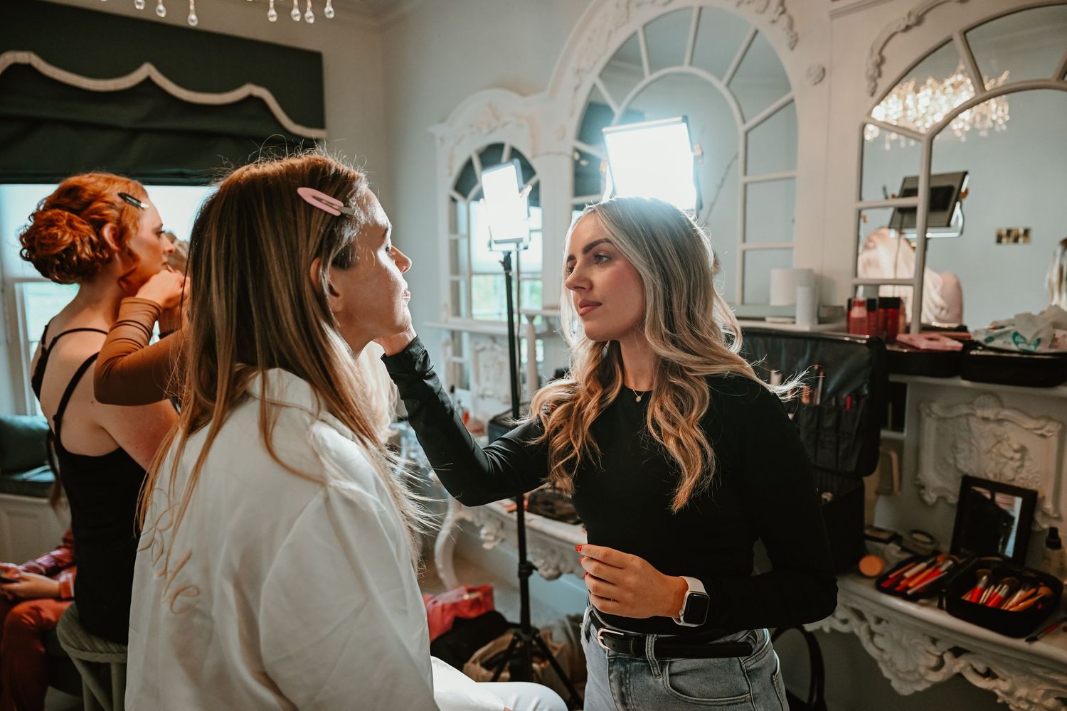 A collection of candid moments at a wedding venue showing people getting ready and interacting in a bright interior space.