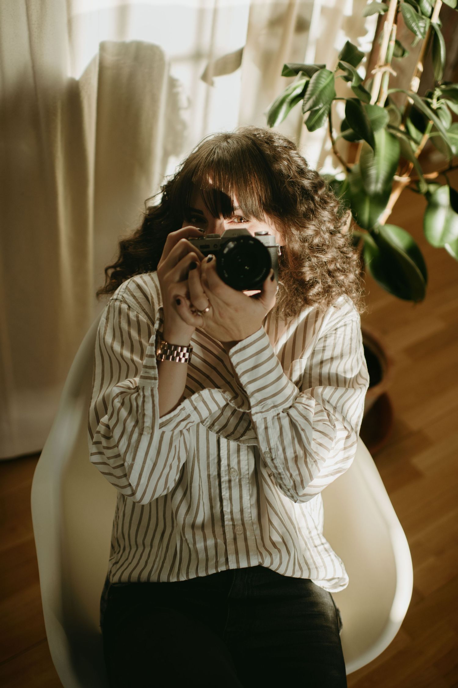 Stockholm brand and event photographer looking from behind her camera and smiling