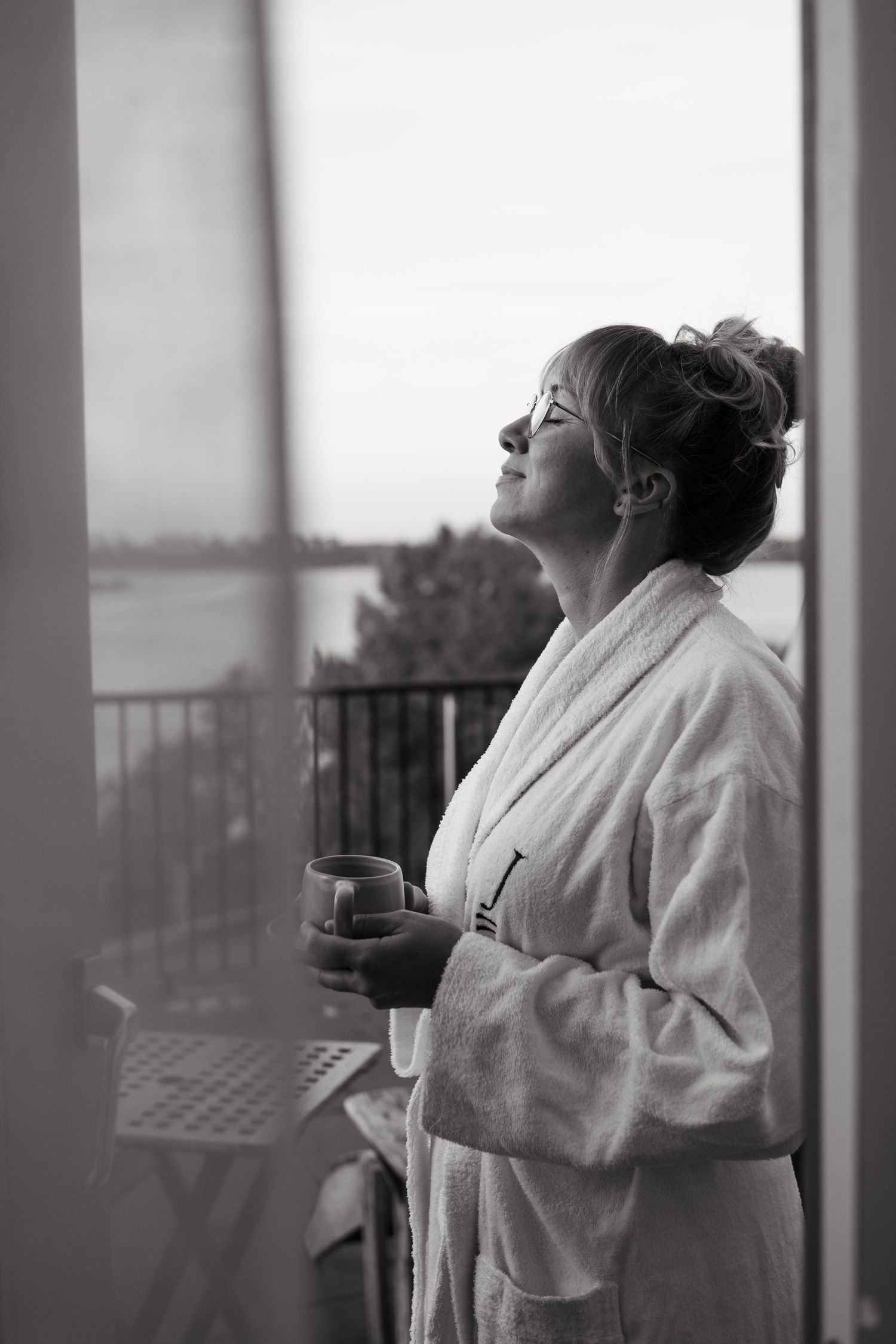 a woman enjoying moment on a terrace of hotel suite during hotel photoshoot in Stockholm