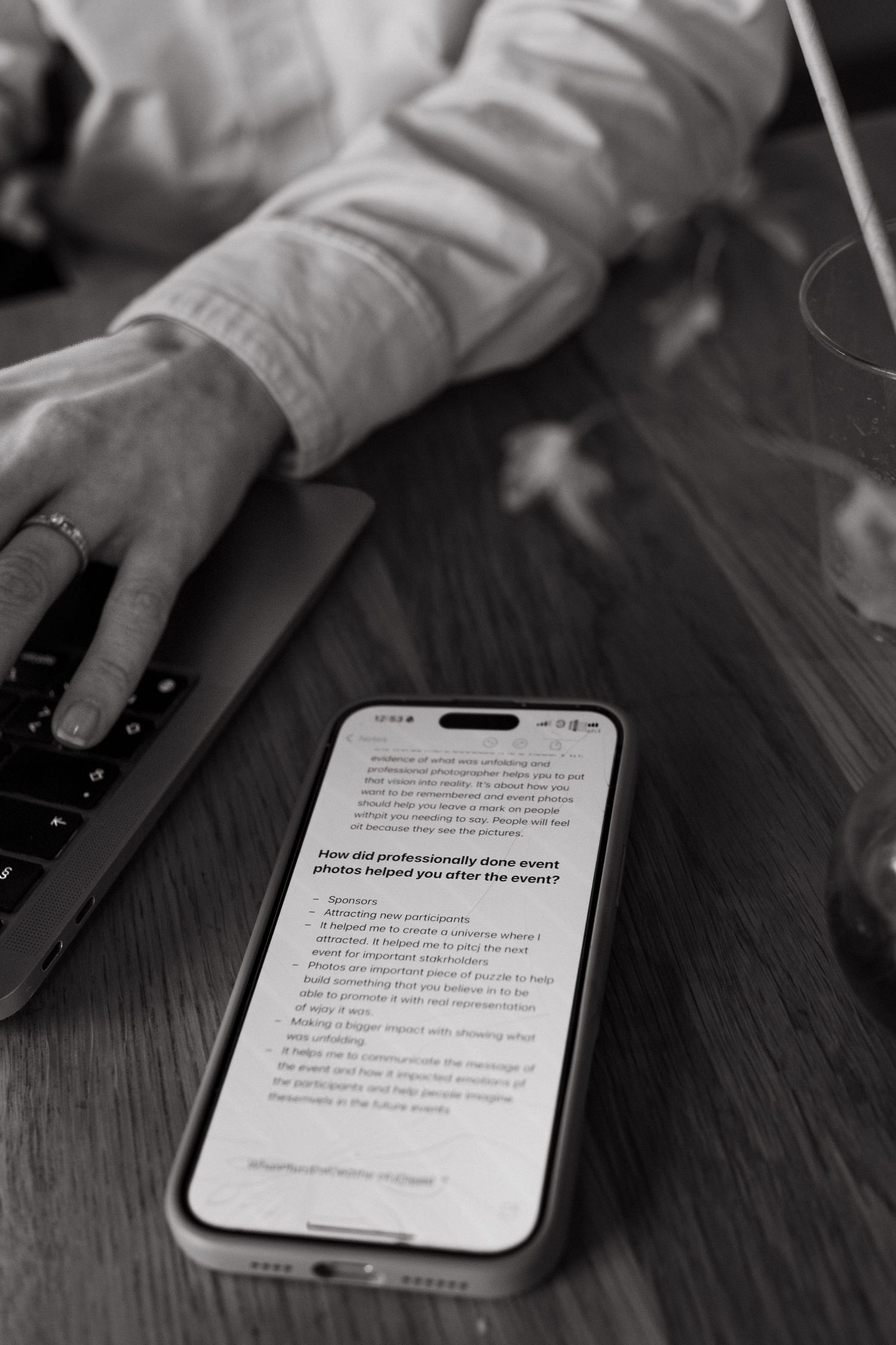 detail of a phone on a table with branding questions during interview about event photography in Stockholm