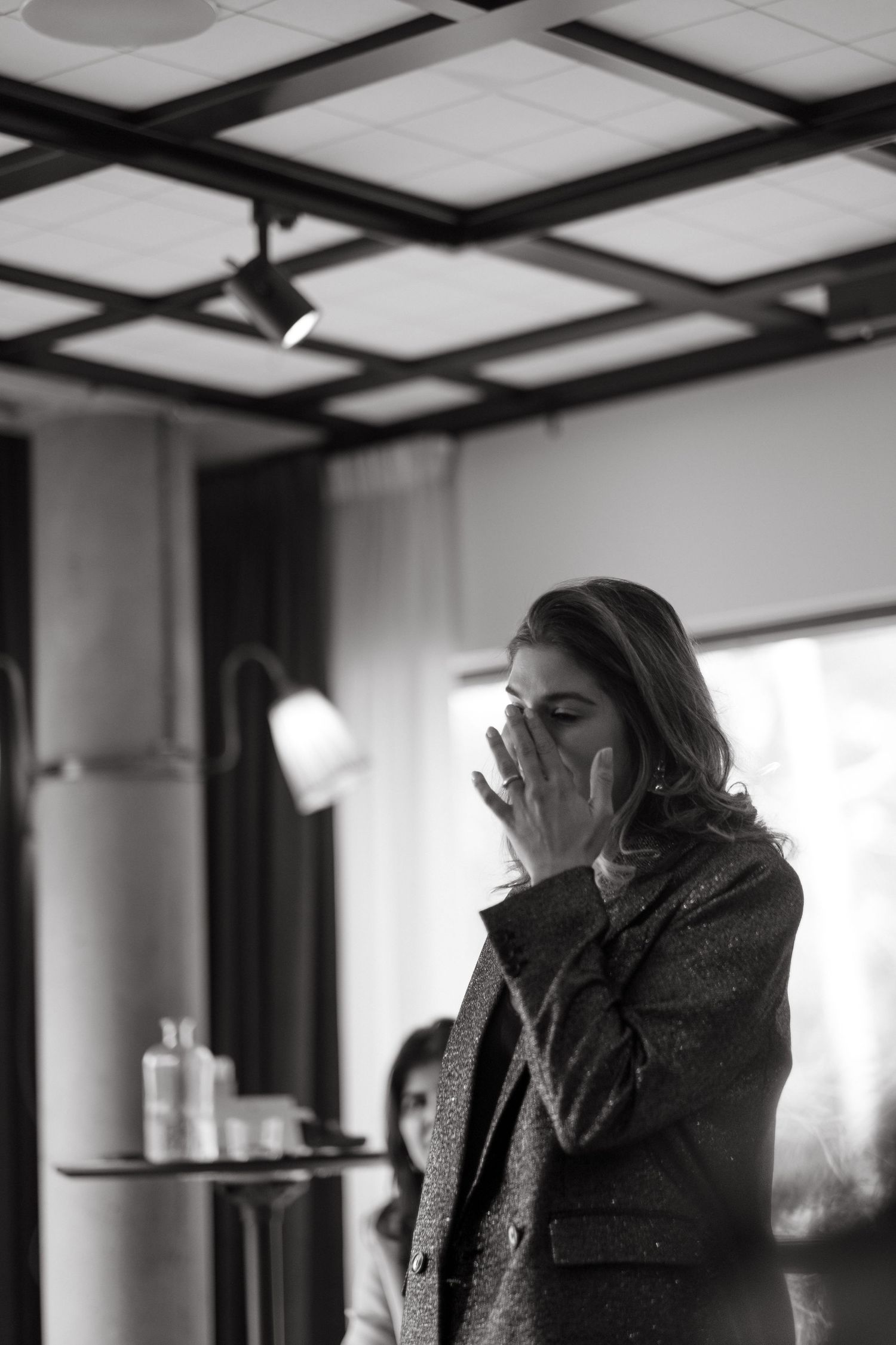 a woman wiping her tears of joy while being captured by Stockholm event photographer at Ellery Beach House