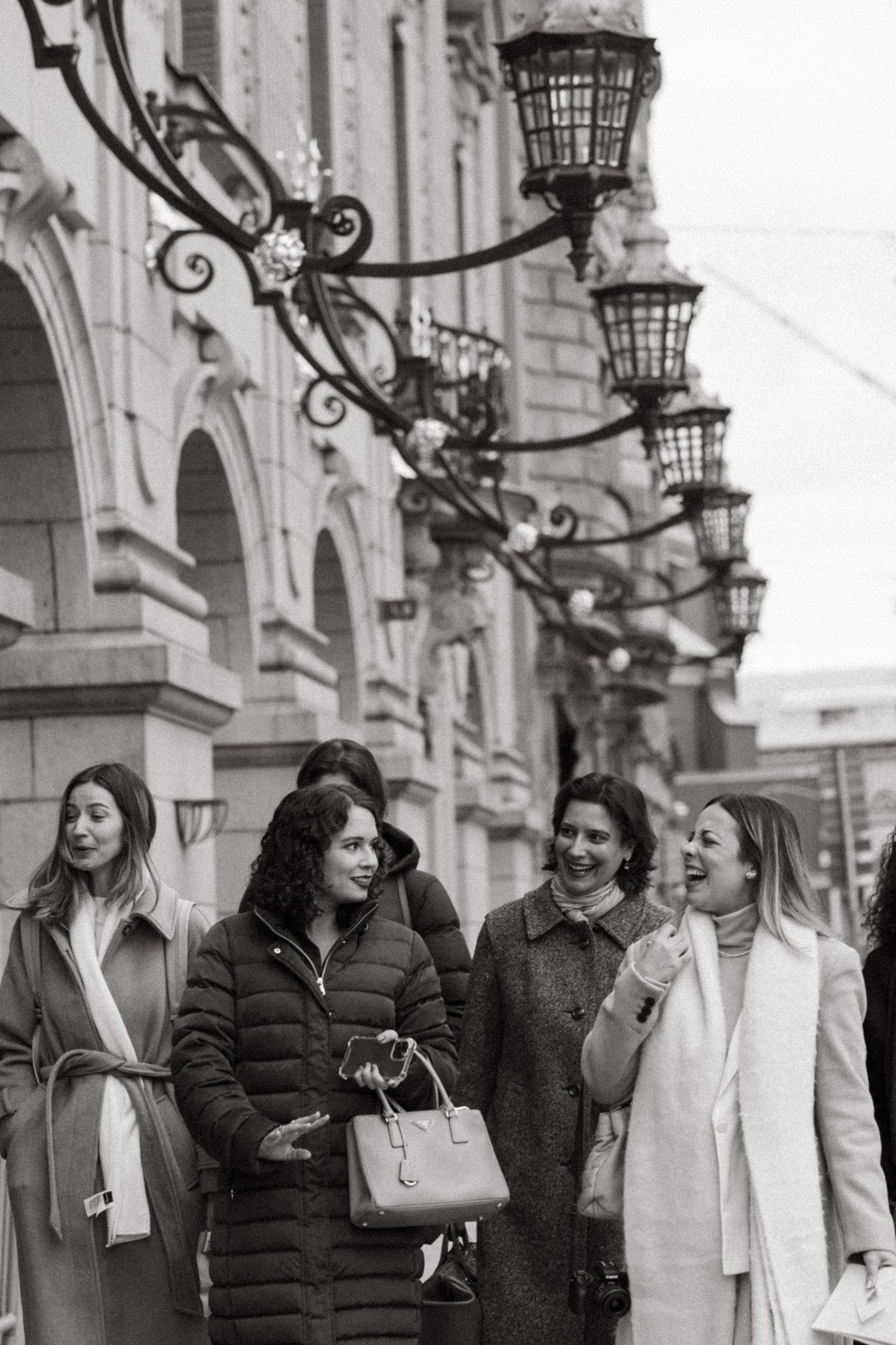 a group of women walking through a street in Stockholm while being captured by event photographer