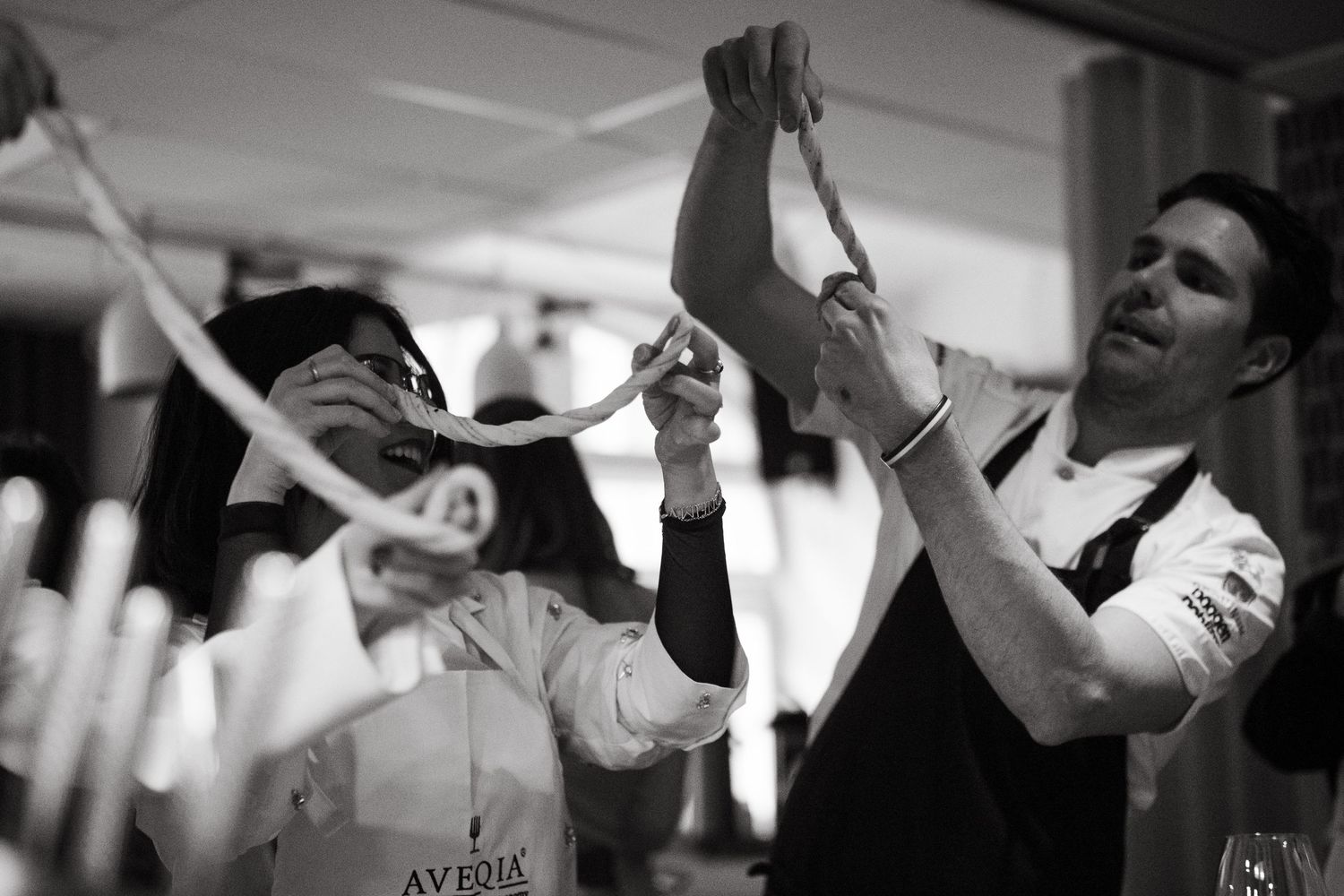 people making cinnamon buns, twisting the dough in their fingers at an exclusive venue for networking event in Stockholm