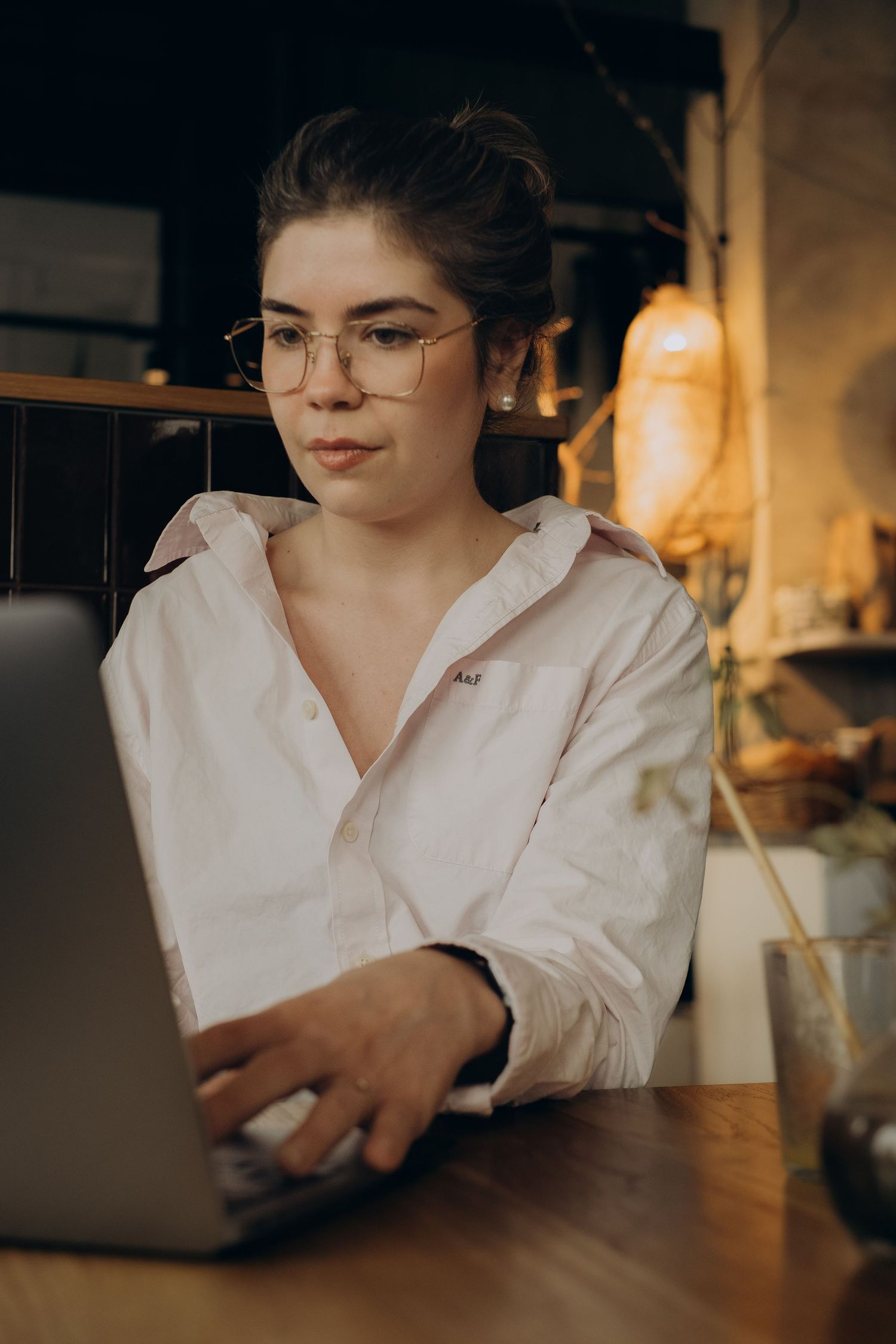 woman focusing on typing on her laptop while being captured by business photographer in Stockholm