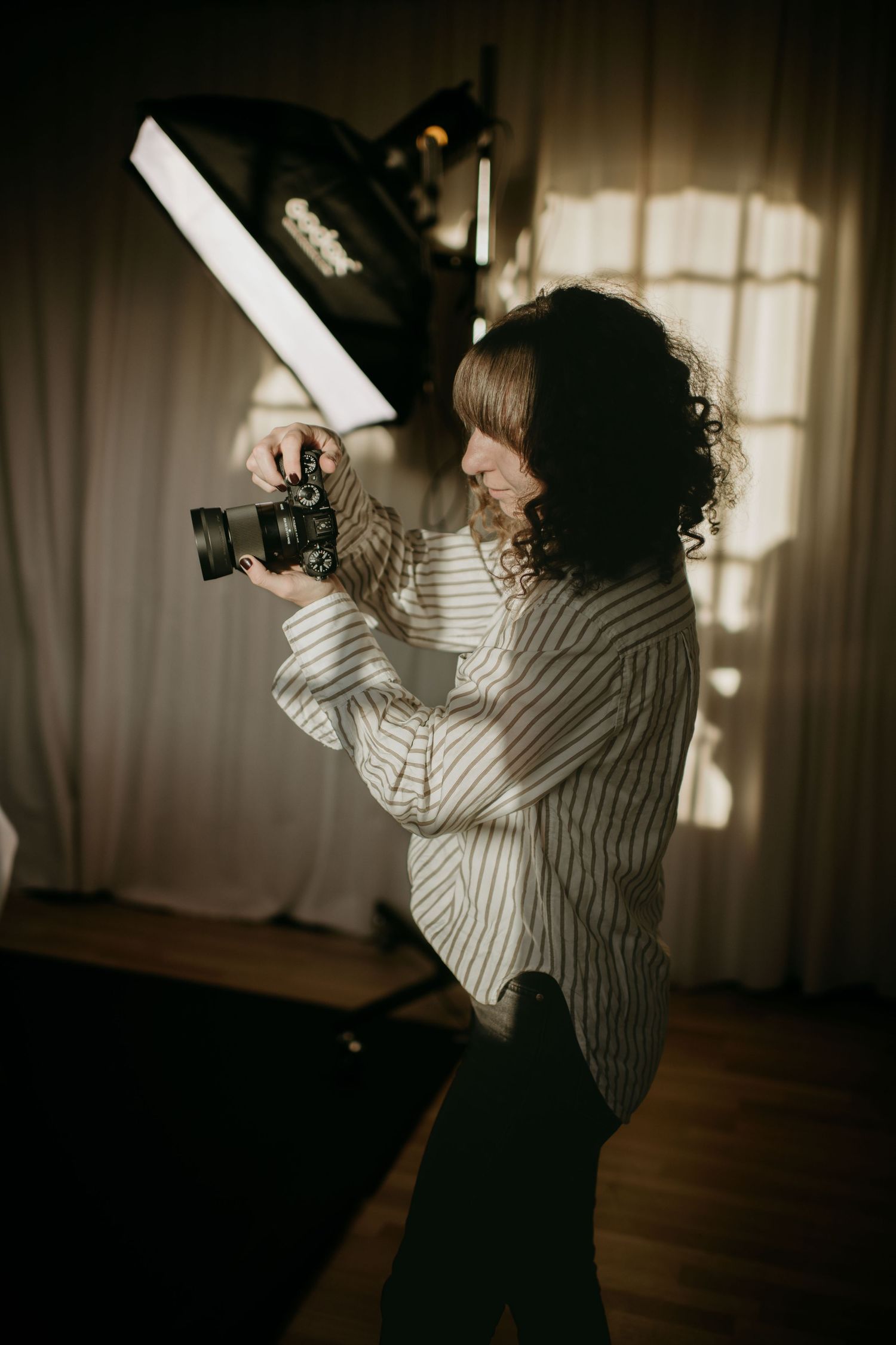 brand photographer in Stockholm standing in a studio and photographing