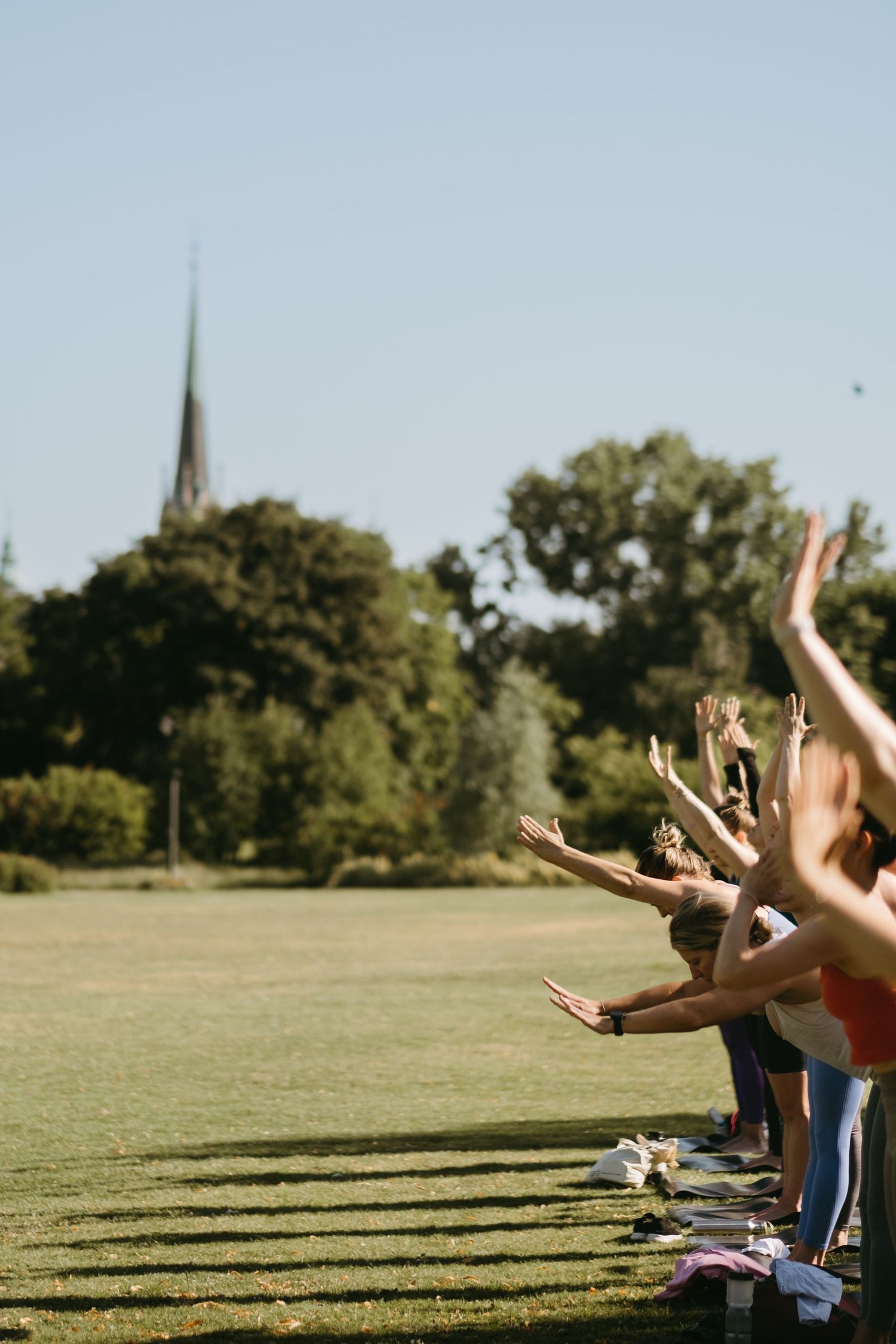 a detail on hands of people practising yoga during Lululemon event at Djurgården while being captured by Stockholm retre
