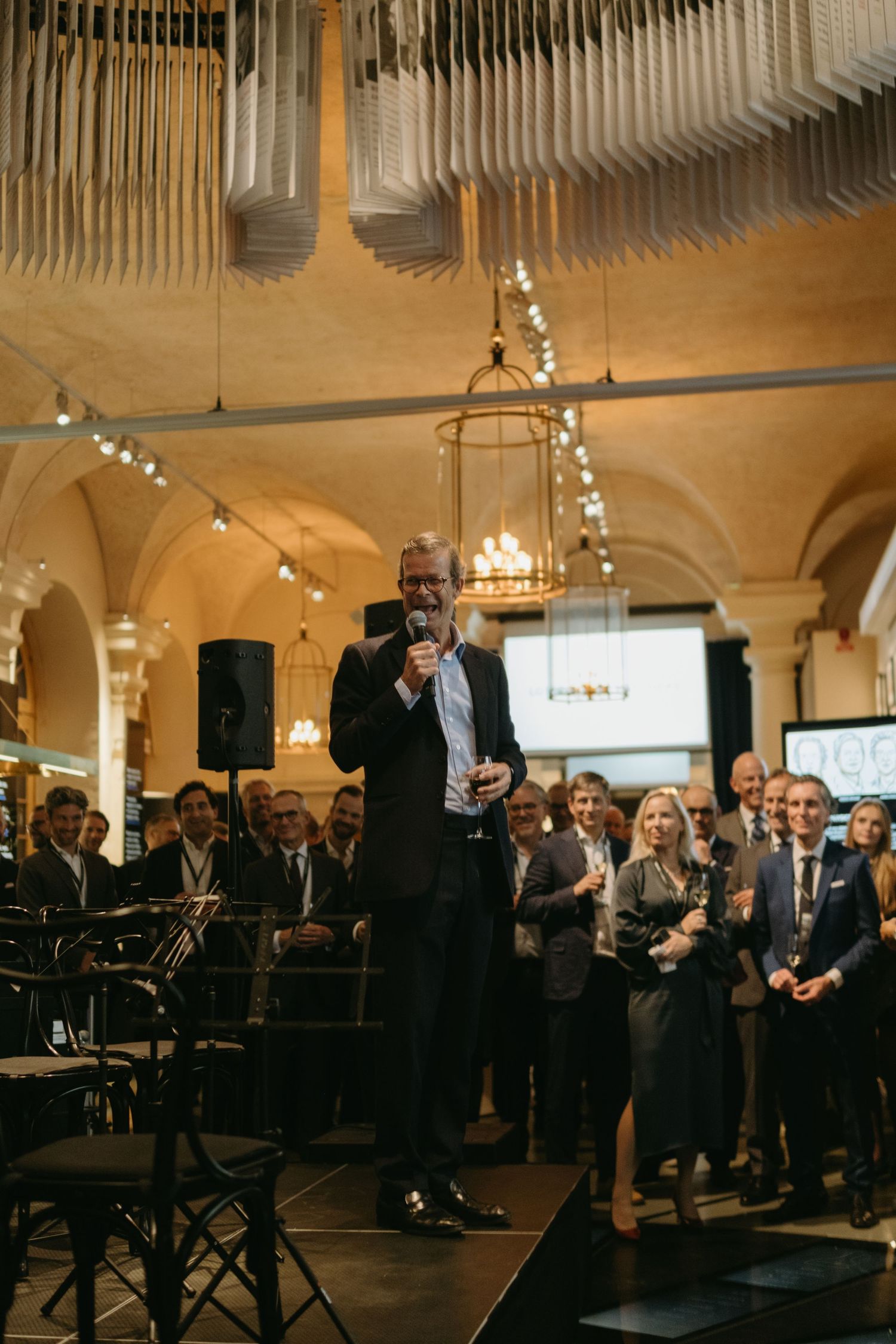 a man giving speech to audience at Nobel Prize Museum while being captured by corporate event photographer in Stockholm