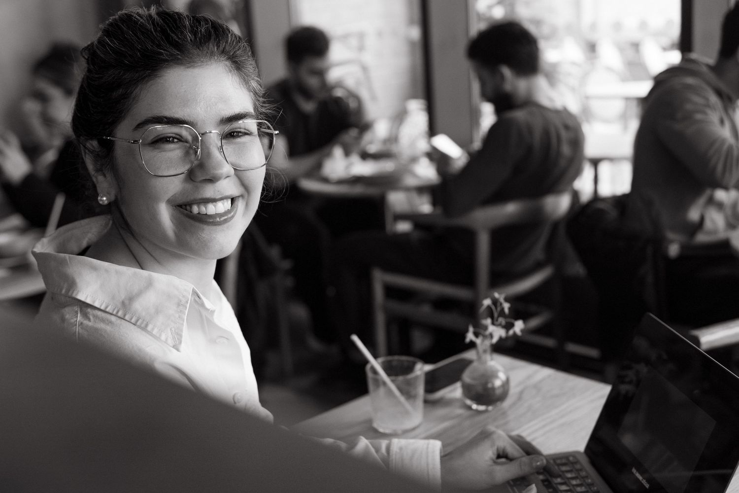 woman looking into camera smiling while being captured by event photographer in Stockholm