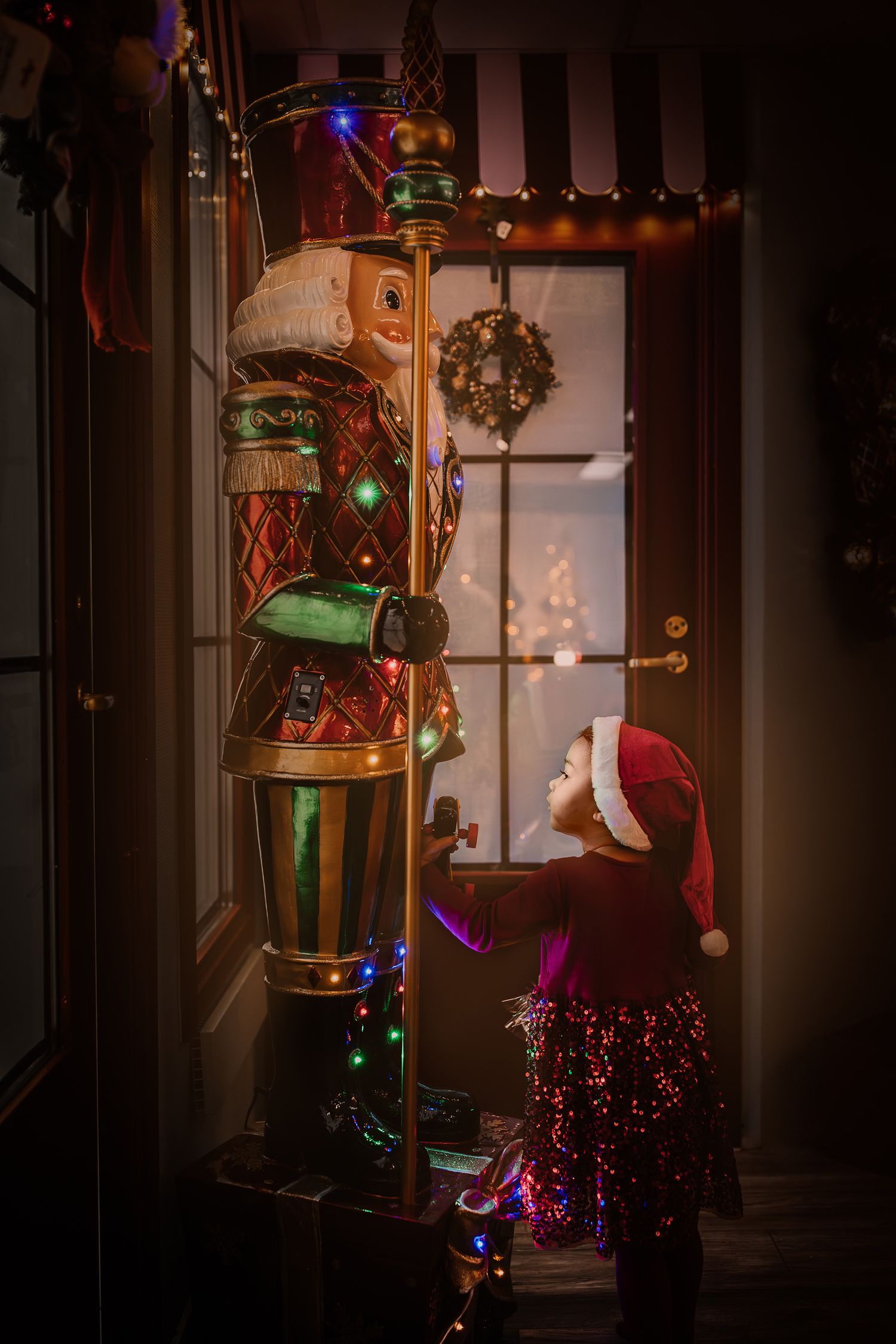 Colorful Christmas decorations and lights arranged in a cozy corner with a festive nutcracker display.