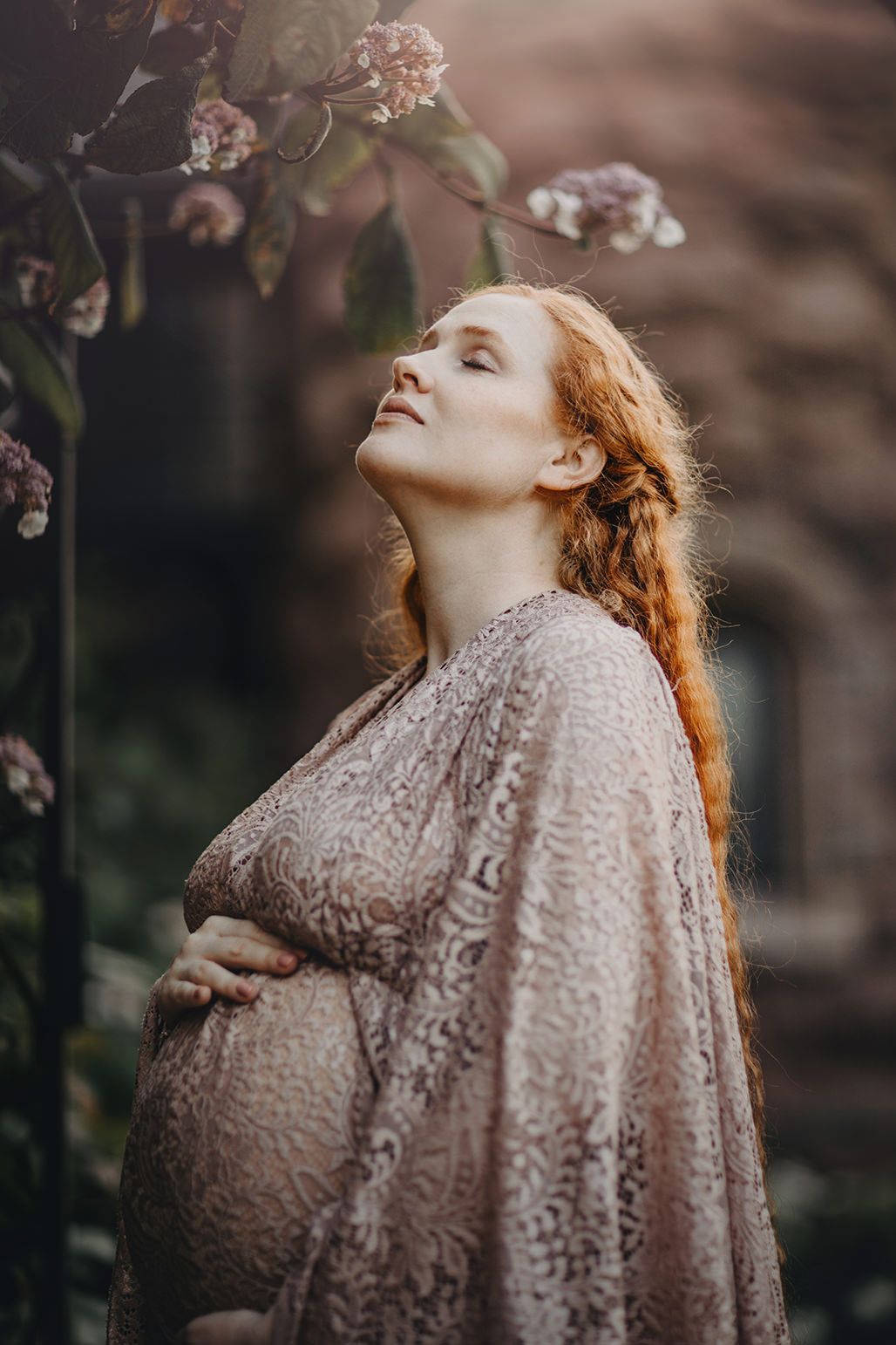 A dreamy portrait series shows someone with ginger hair wearing a lace dress amid blossoms in soft natural light.
