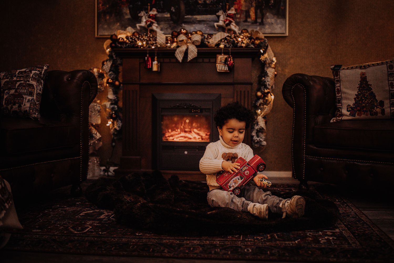 Cozy Christmas scene by a fireplace with decorative garland and warm lighting.