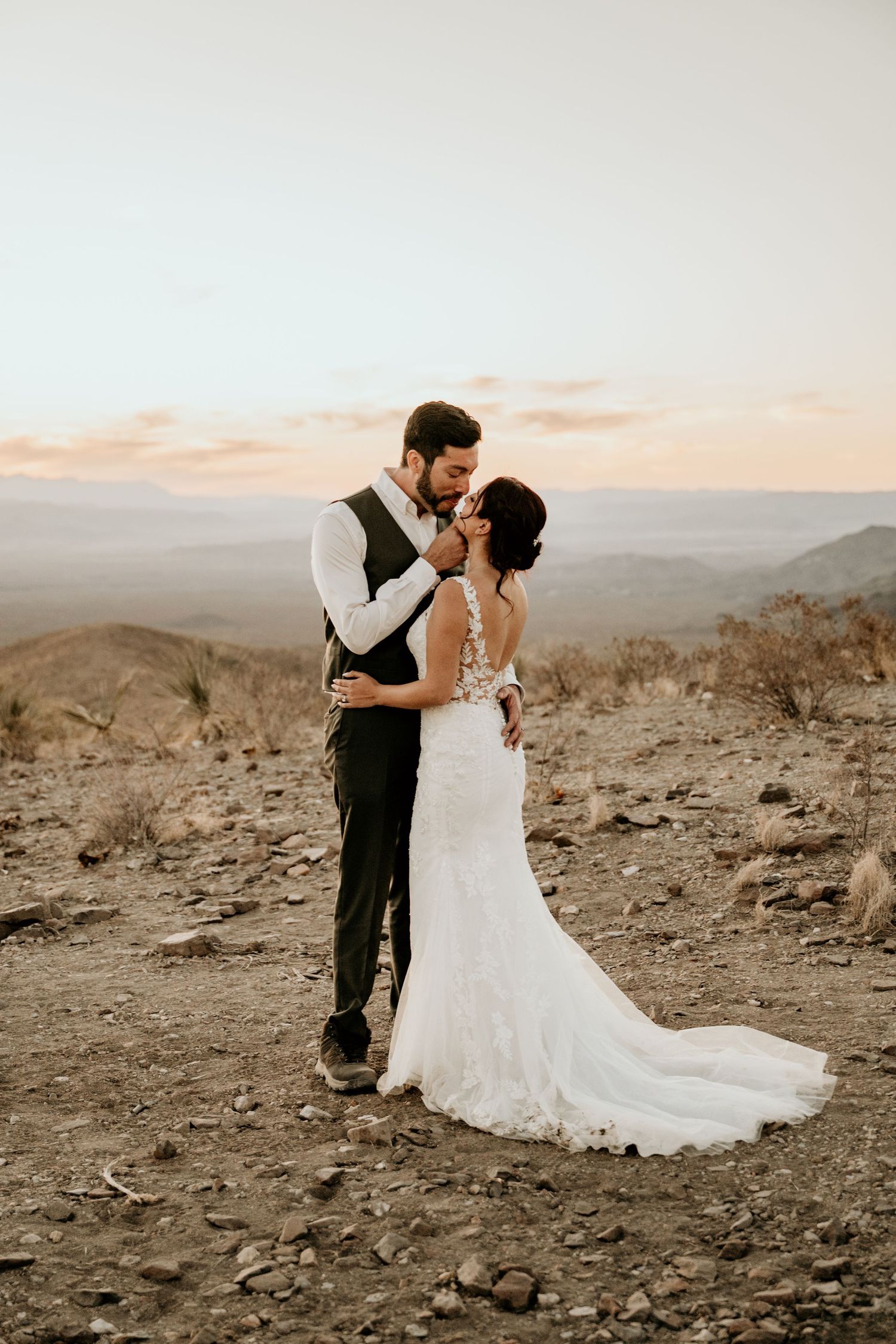 Artistic wedding photography sequence showing romantic poses against a rugged desert landscape.