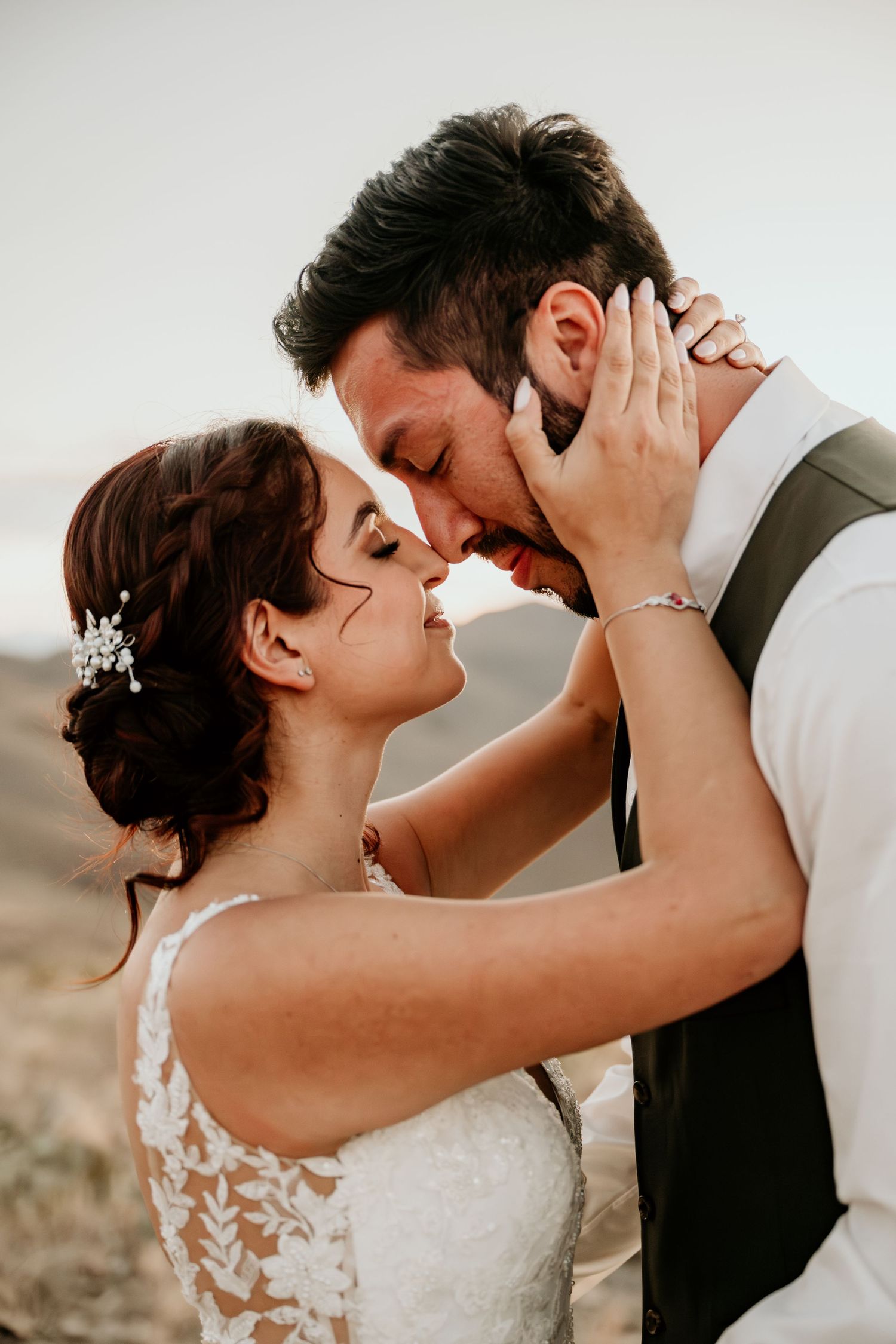 Intimate wedding portrait sequence showing tender moments between newlyweds against a desert backdrop.
