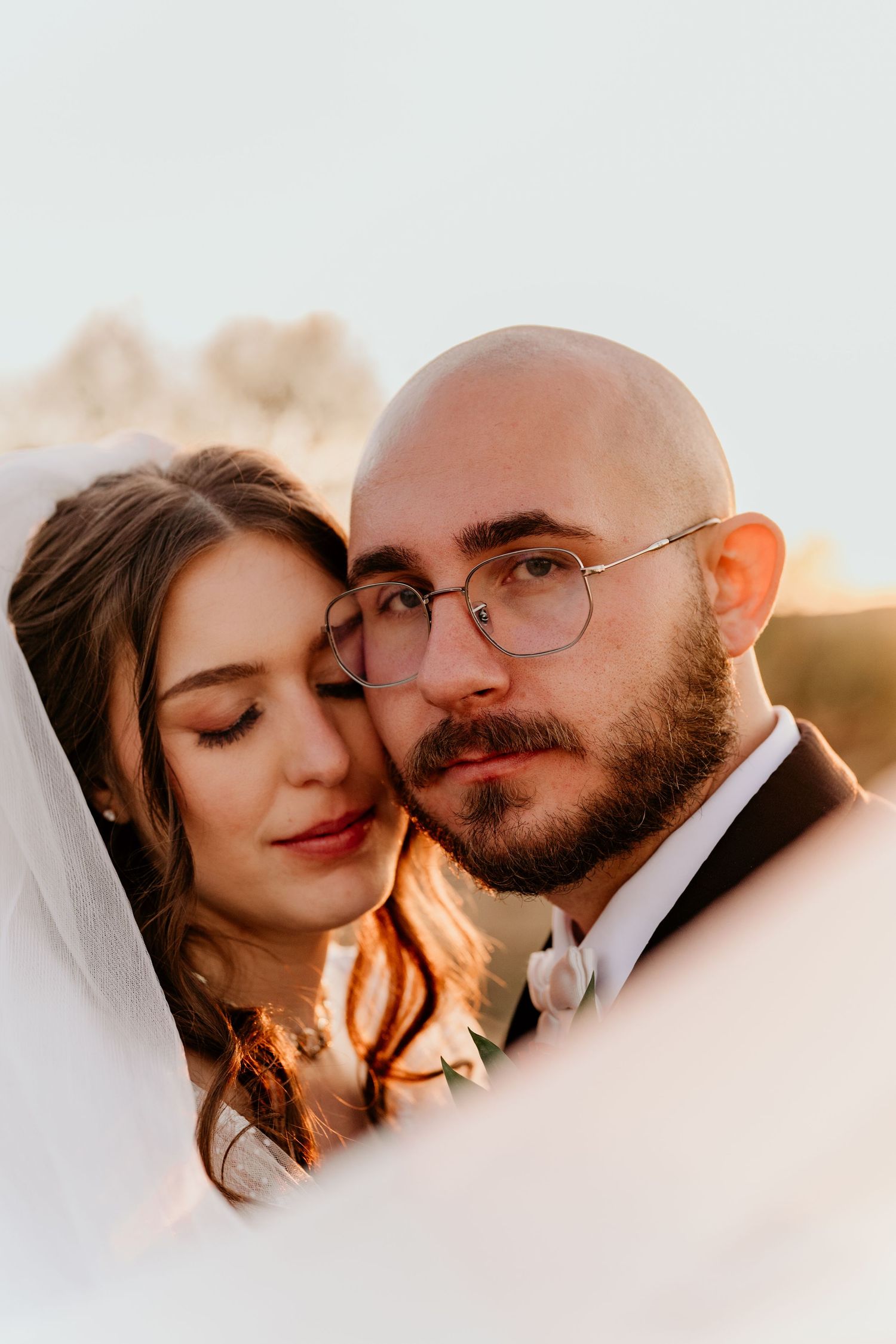 Romantic sunset wedding portraits captured in a dreamy, intimate style.