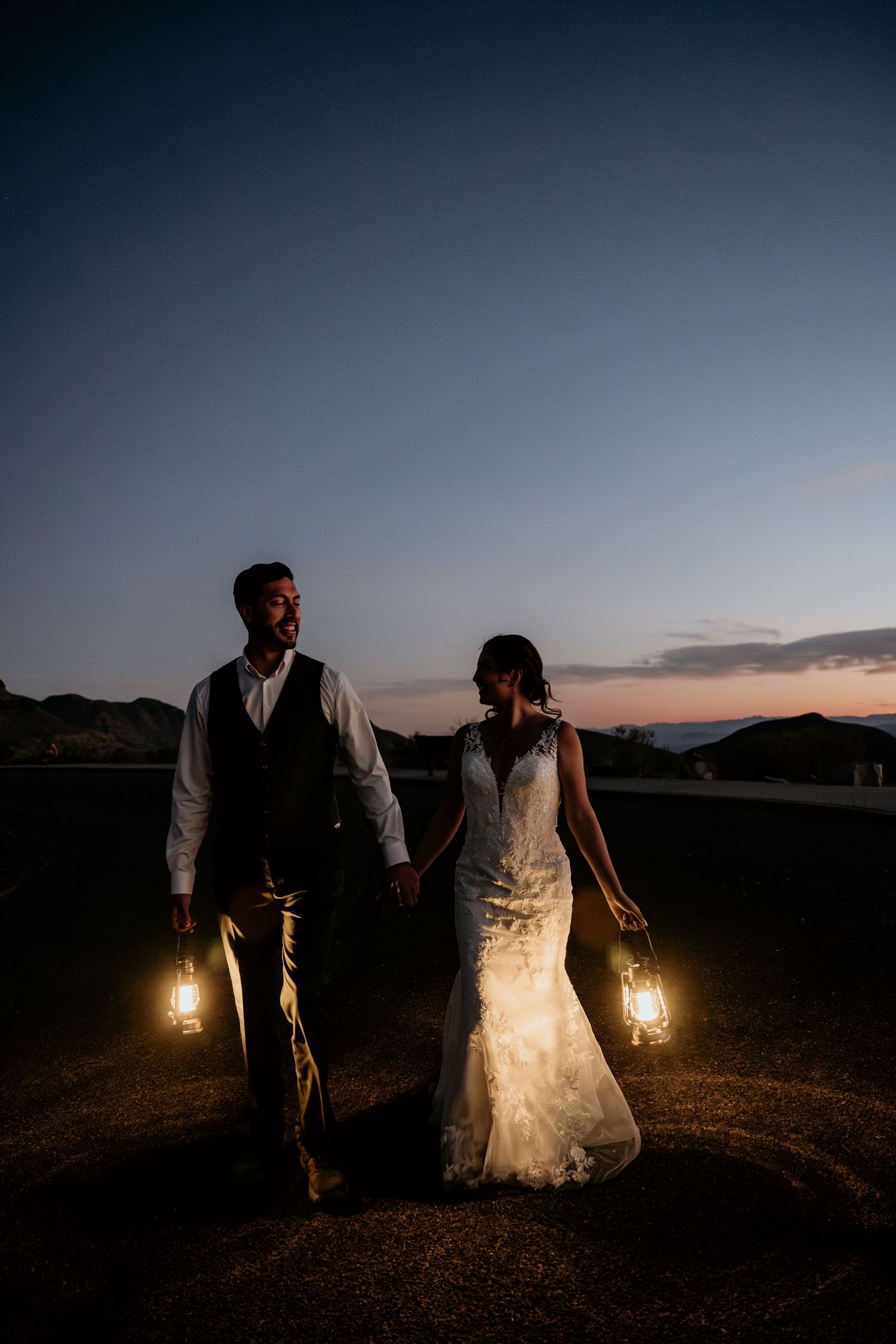 Romantic desert photoshoot with lantern lighting at sunset.