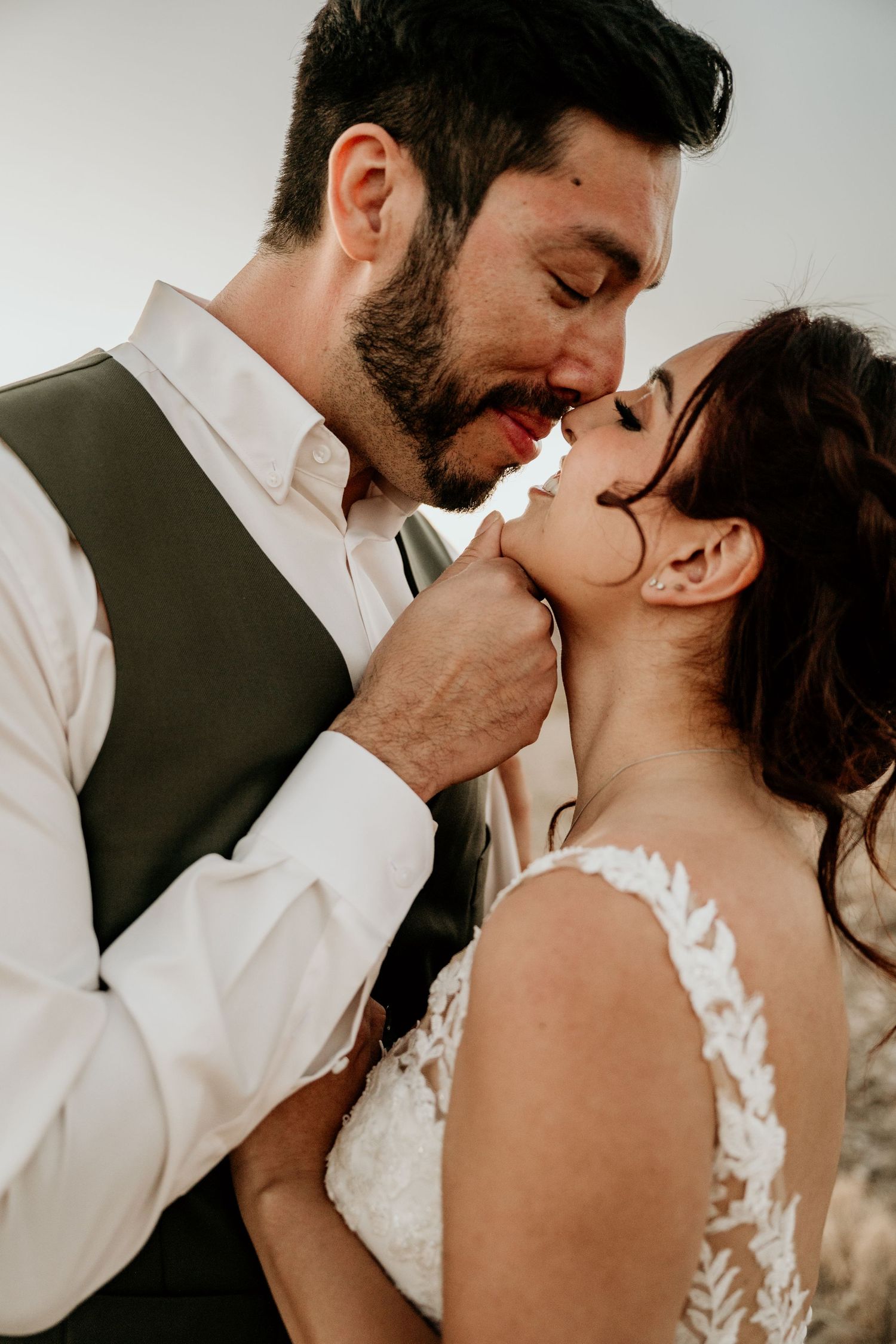 Close-up wedding photography sequence capturing intimate romantic moments in warm desert lighting.