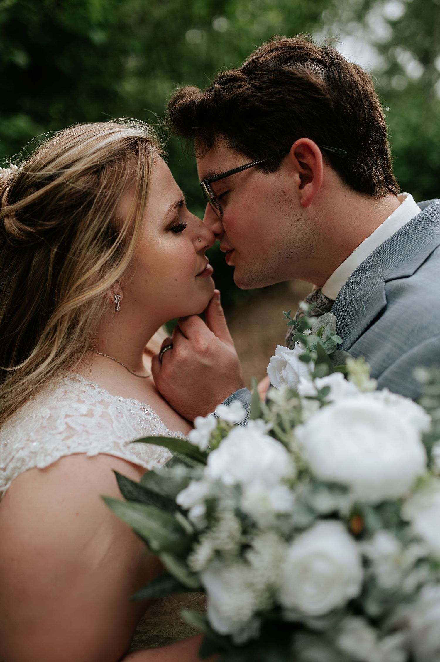 Romantic wedding photography sequence featuring close-up intimate moments between a bride and groom with white florals.