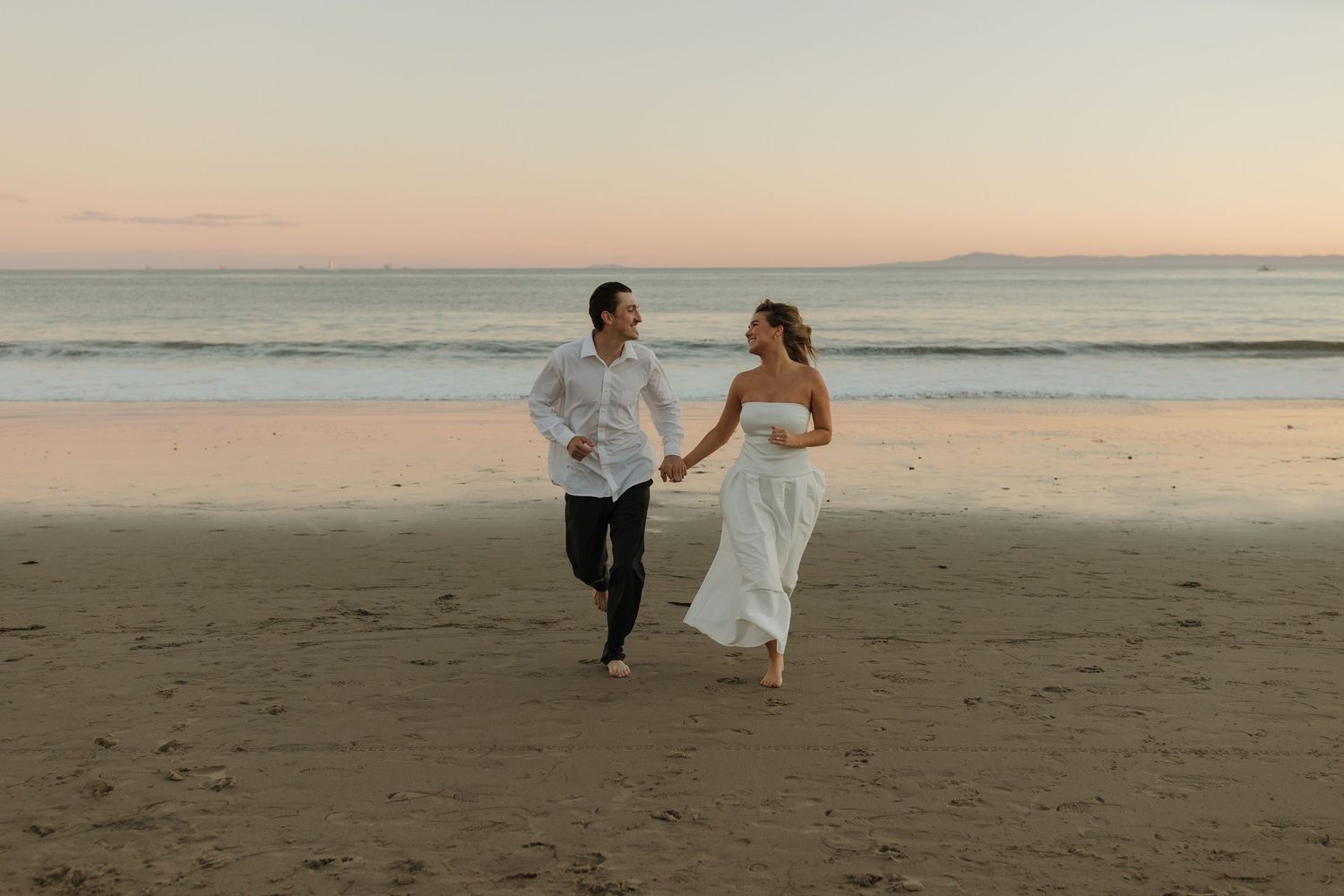 candid beach engagement session